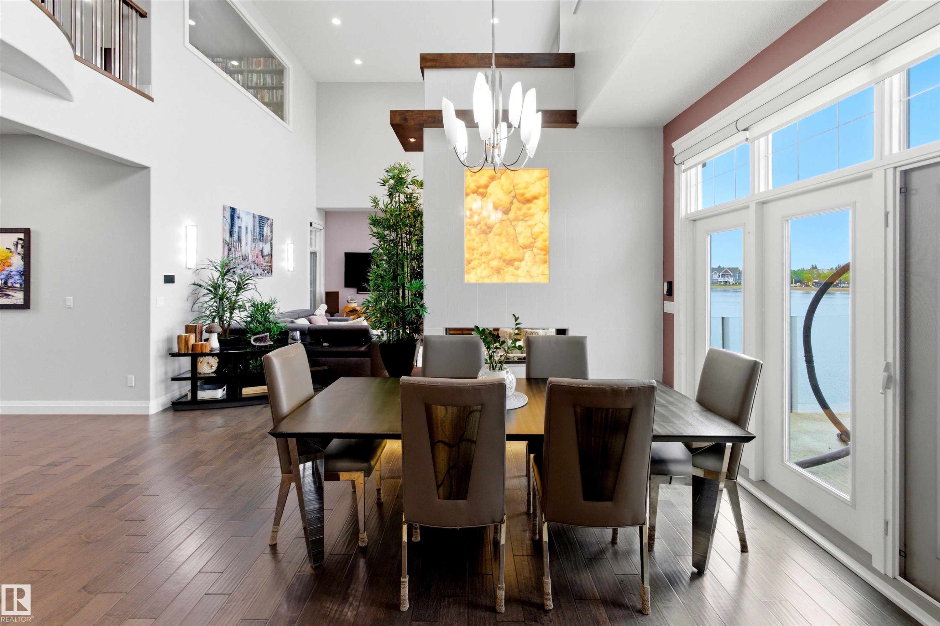 Dining area featuring wood-finish flooring and direct access to exterior through French doors - 9003 16 Avenue Sw, Edmonton, AB - Indoor Photo Showing Dining Room