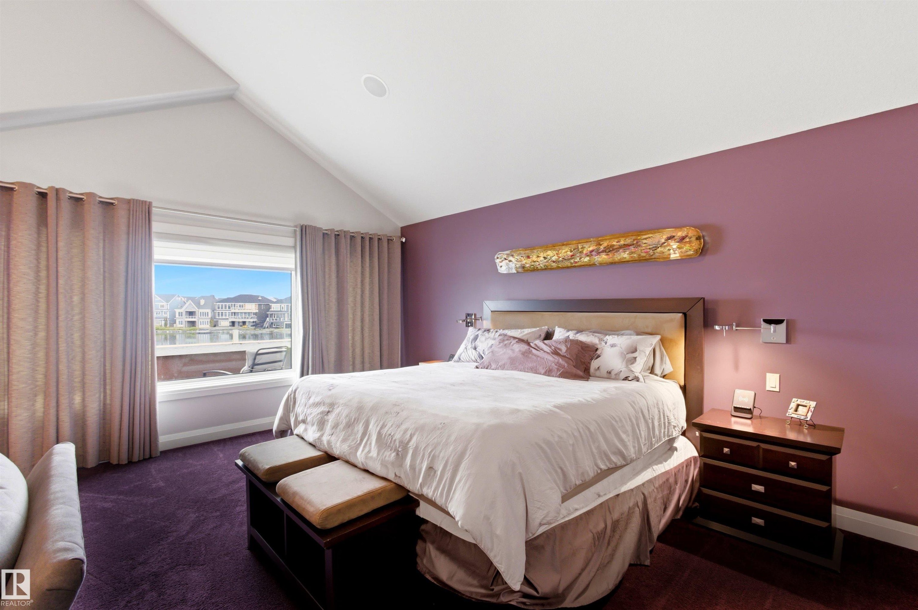 Vaulted ceiling room featuring a large picture window, recessed lighting, and a vibrant accent wall - 9003 16 Avenue Sw, Edmonton, AB - Indoor Photo Showing Bedroom
