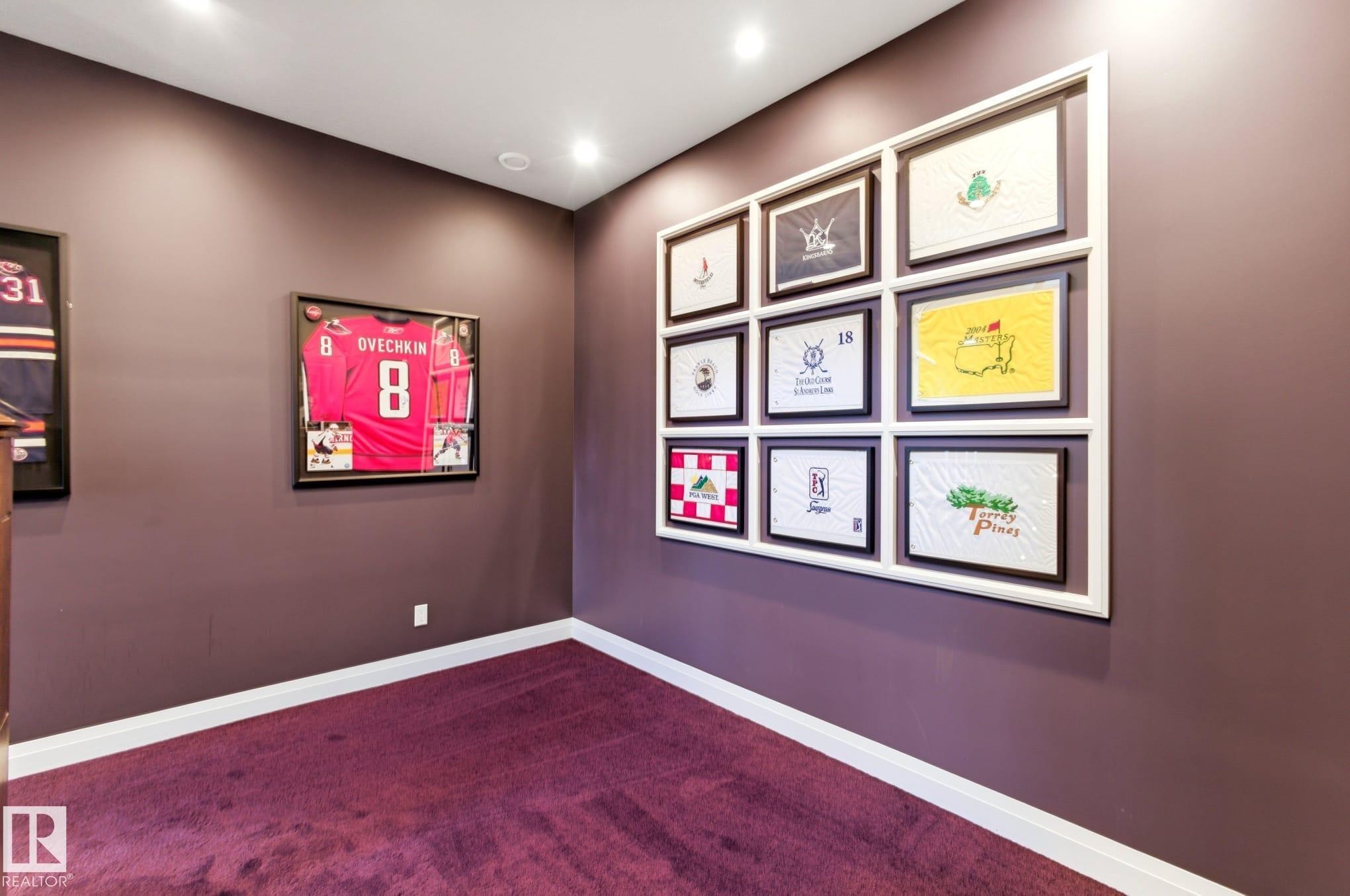 Accent wall with built-in gallery framing, recessed lighting, deep purple carpeting, and white baseboards - 9003 16 Avenue Sw, Edmonton, AB - Indoor Photo Showing Other Room
