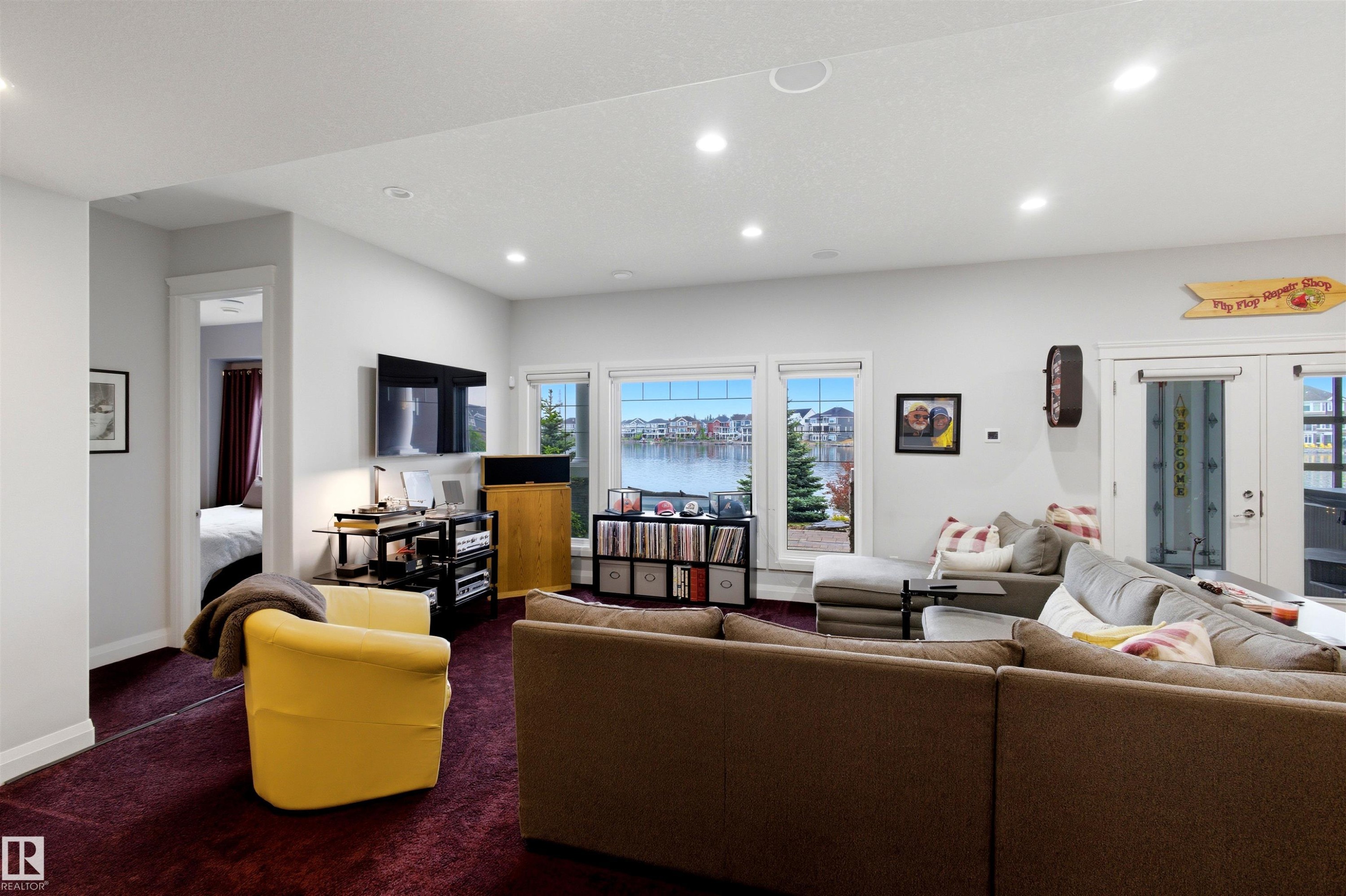 Living area featuring a textured maroon carpet and recessed lighting - 9003 16 Avenue Sw, Edmonton, AB - Indoor Photo Showing Living Room