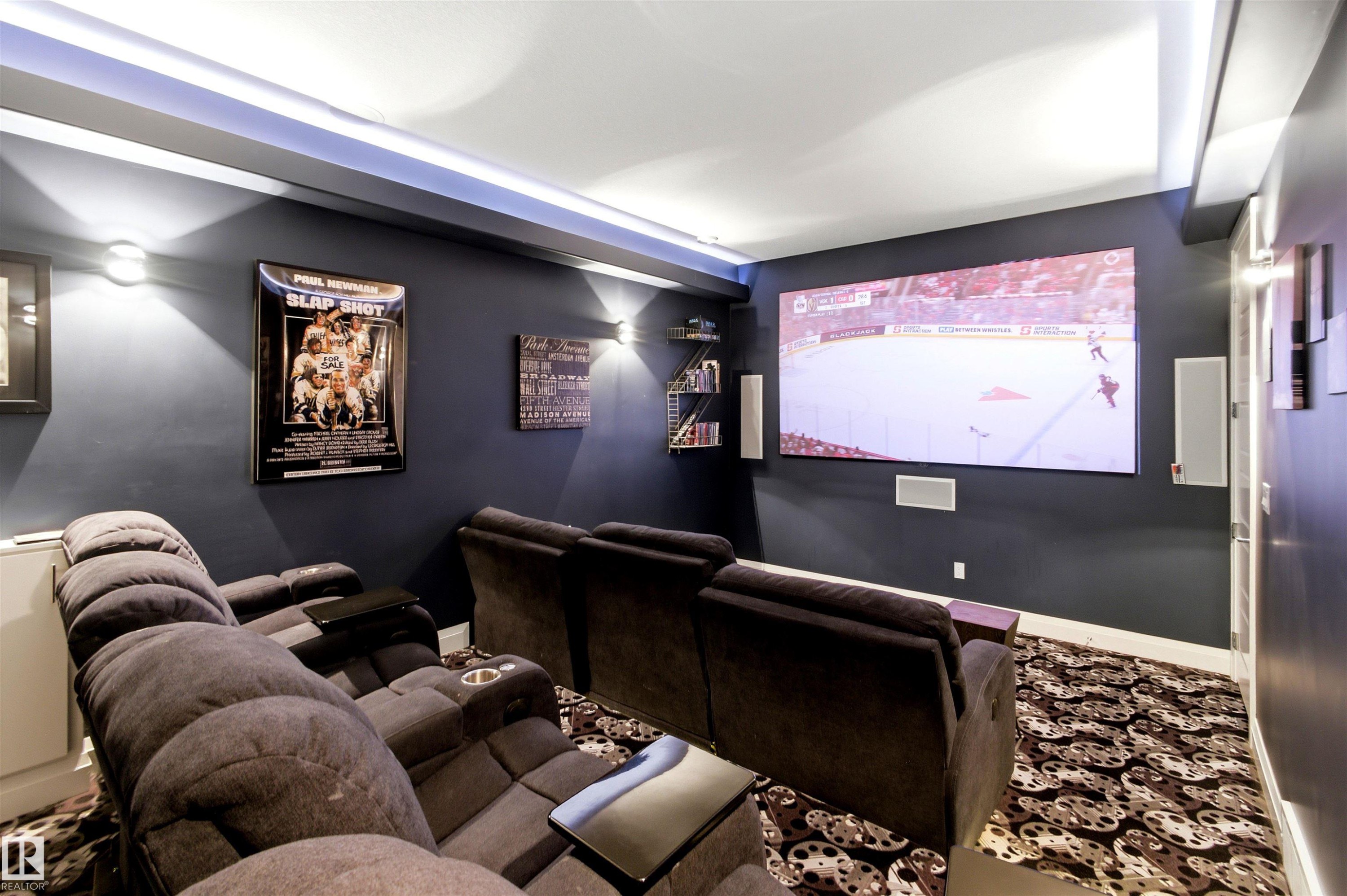Dedicated media room featuring a large projection screen, recessed ceiling lighting, and wall-mounted sconces - 9003 16 Avenue Sw, Edmonton, AB - Indoor Photo Showing Other Room