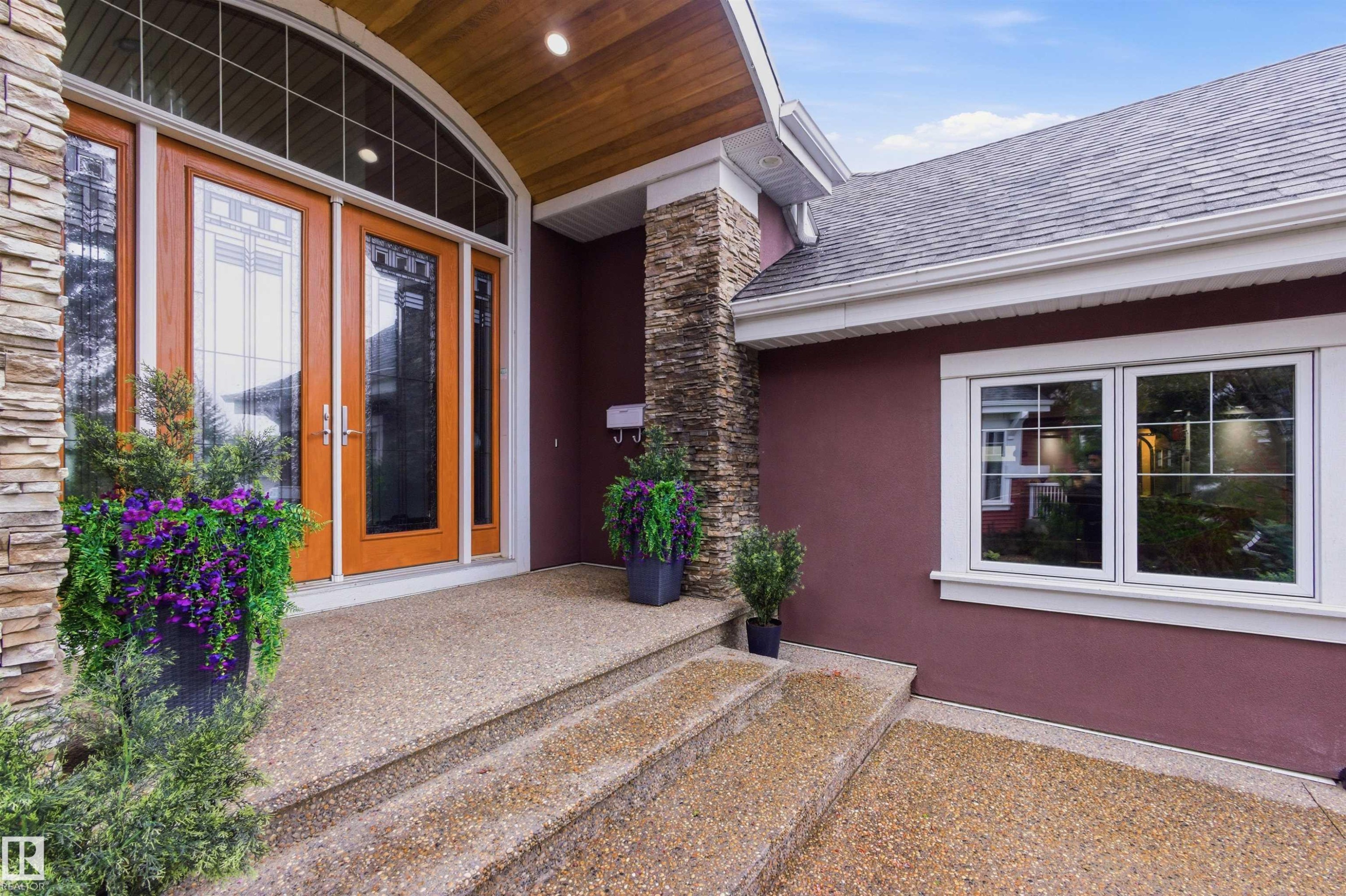 Inviting entry featuring double doors with decorative glass inserts and an arched transom window - 9003 16 Avenue Sw, Edmonton, AB - Outdoor With Exterior