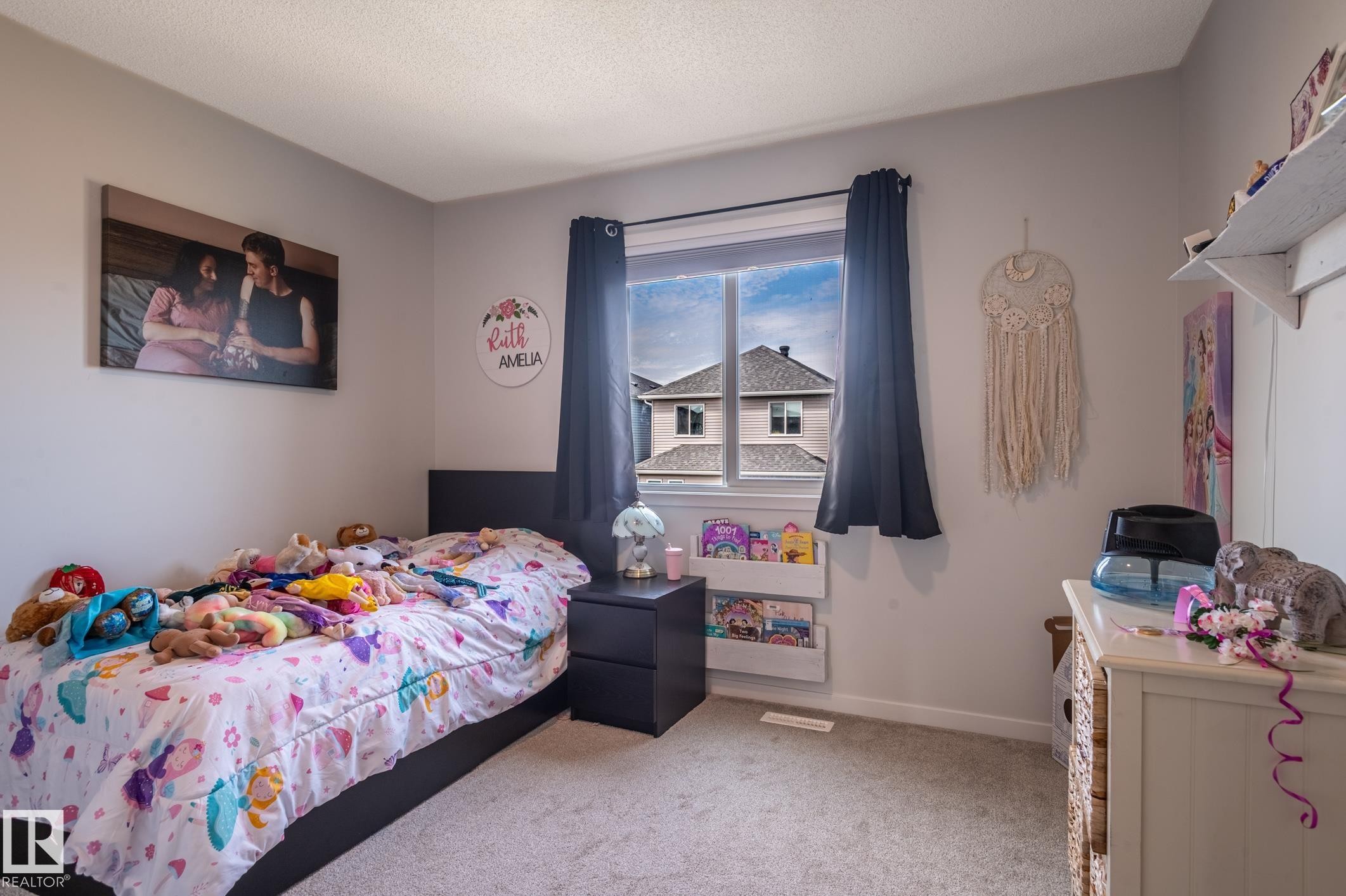 Light gray walls defining a room with a window, carpeted flooring, and white baseboards - 17562 63A Street, Edmonton, AB