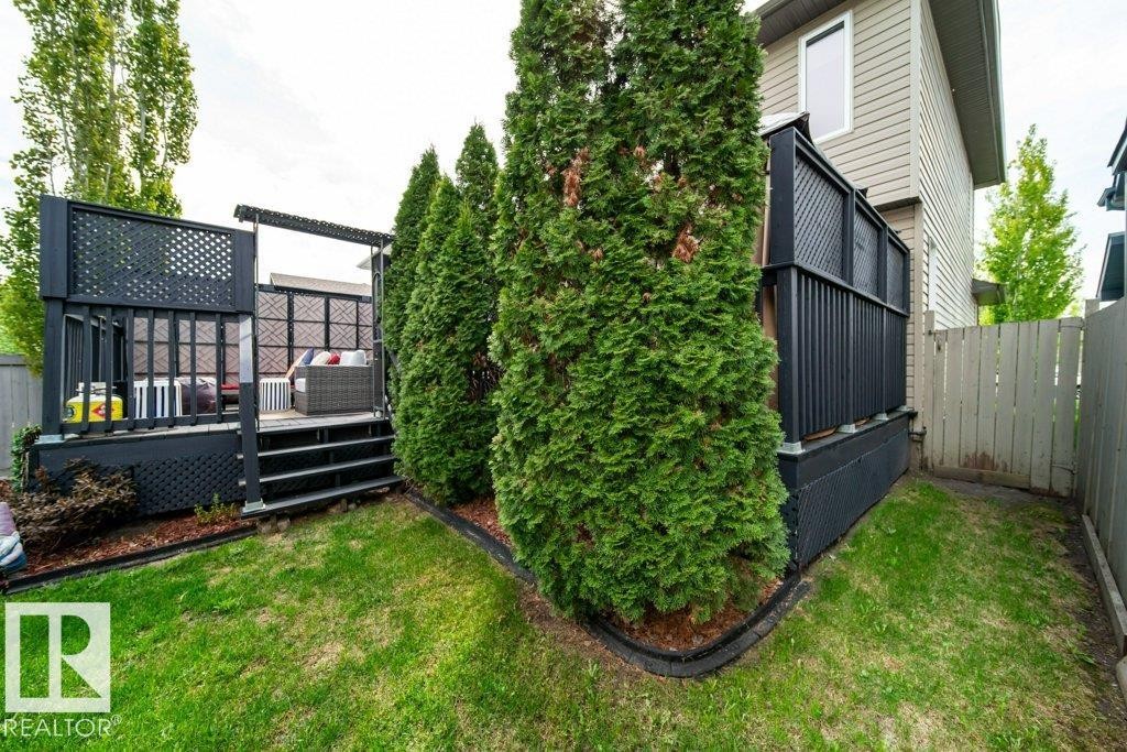 Raised deck with dark-stained wood railings and lattice accents - 8507 2 Avenue Sw, Edmonton, AB - Outdoor With Deck Patio Veranda With Exterior