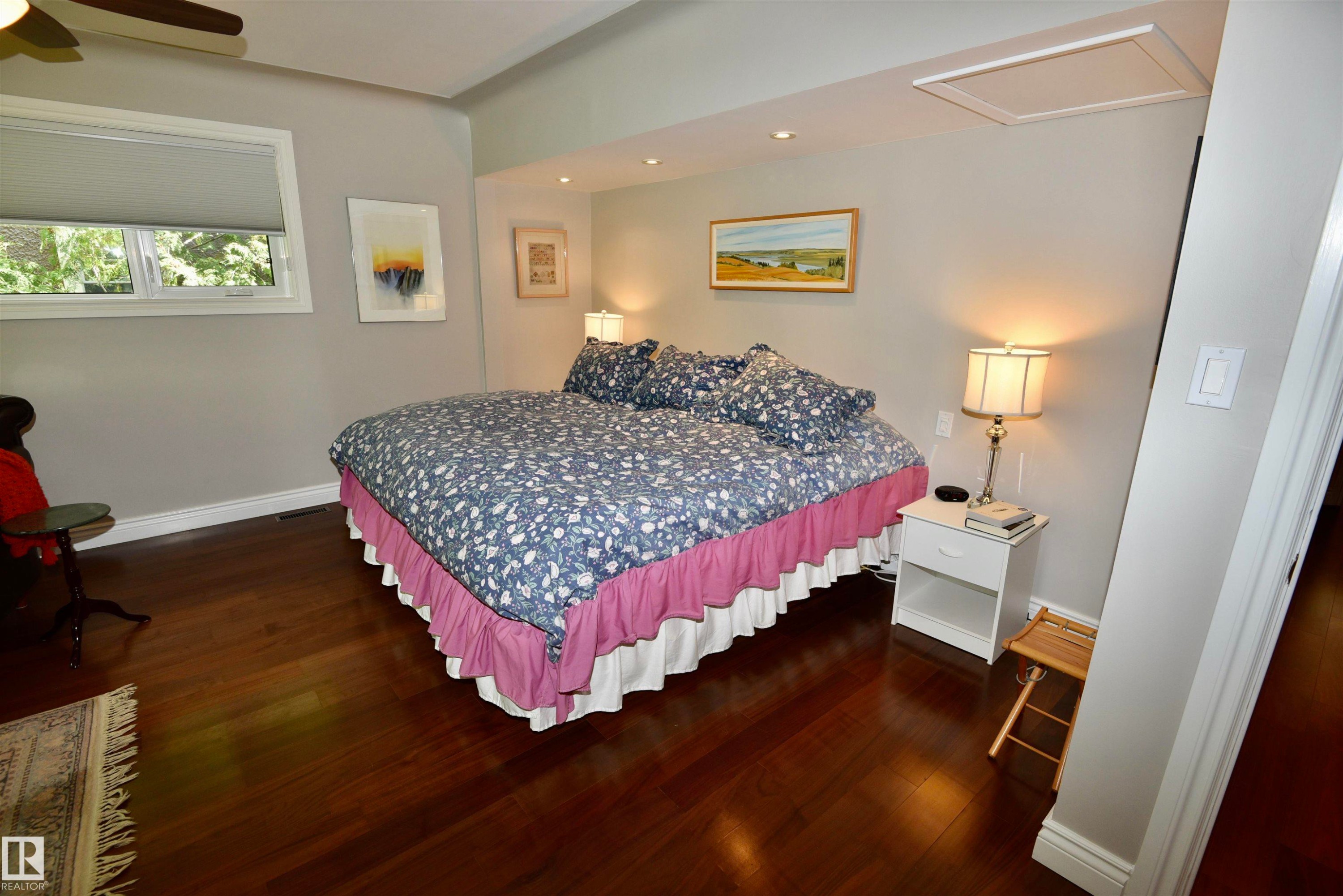 Bedroom featuring rich wood-finish flooring, recessed lighting, and a ceiling fan - 6 St George'S Crescent, Edmonton, AB