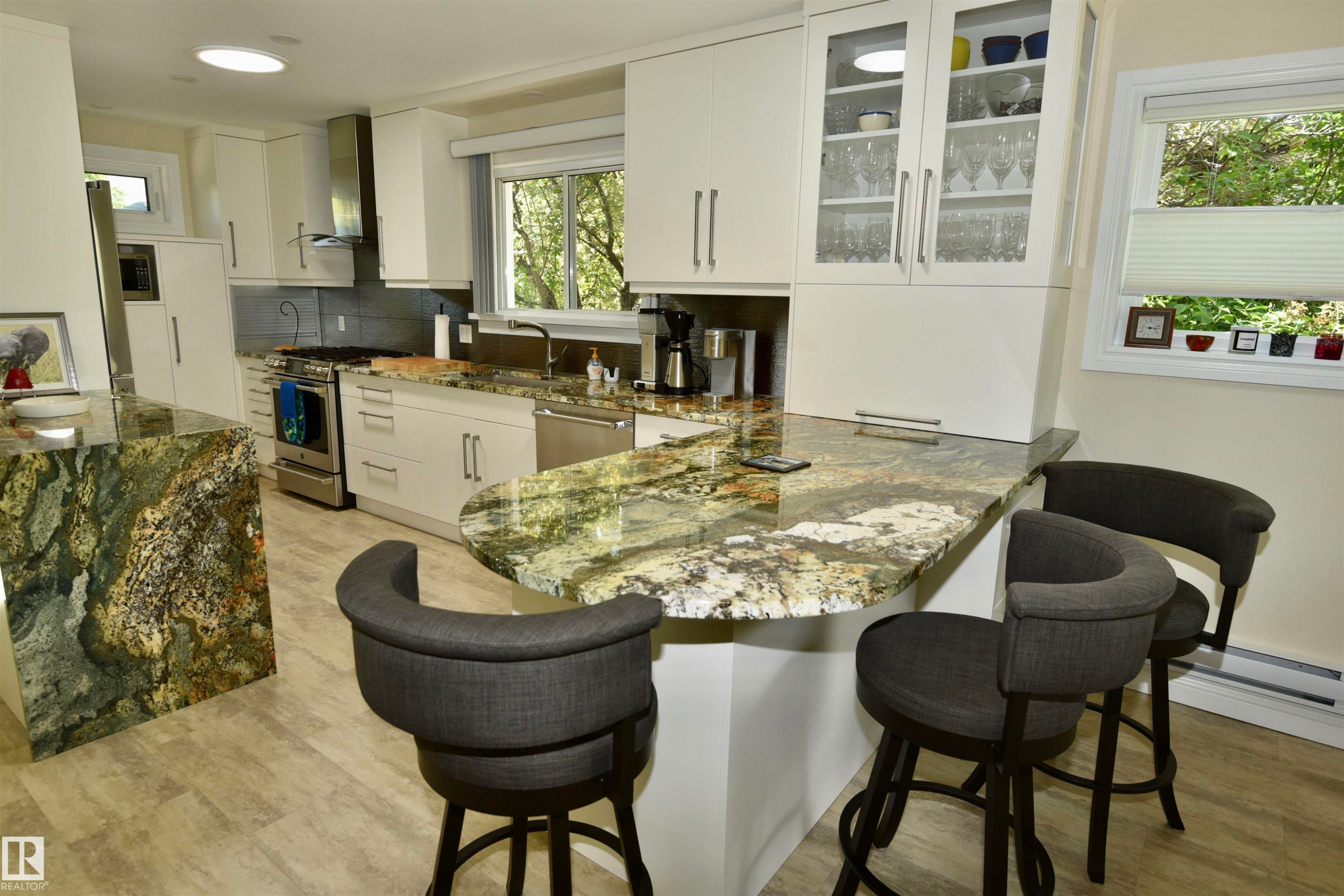 Kitchen featuring stone countertops, white cabinetry, stainless steel appliances, and wood-finish flooring - 6 St George'S Crescent, Edmonton, AB