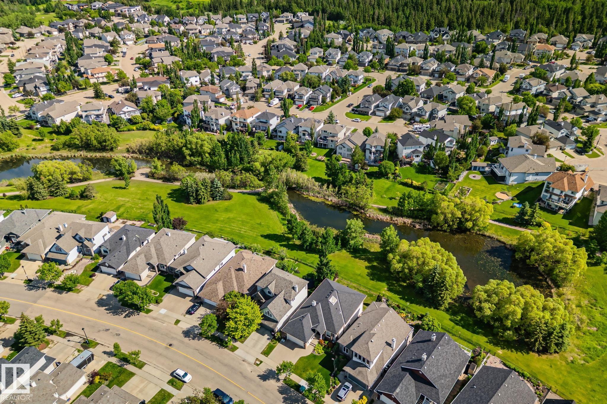 Aerial perspective of Southbrook, featuring extensive green spaces, natural waterways, and mature trees all within walking distance of the subject property. - 591 Byrne Crescent Sw, Edmonton, AB - Outdoor With View