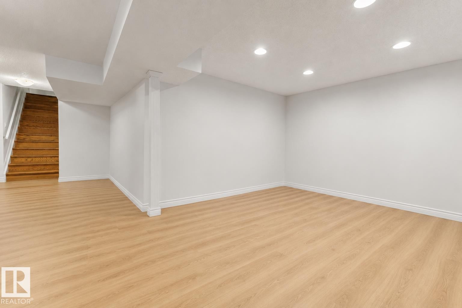 Expansive room featuring light wood-finish flooring, recessed lighting, white walls, and white baseboards - 11234 40 Avenue Nw, Edmonton, AB - Indoor Photo Showing Other Room