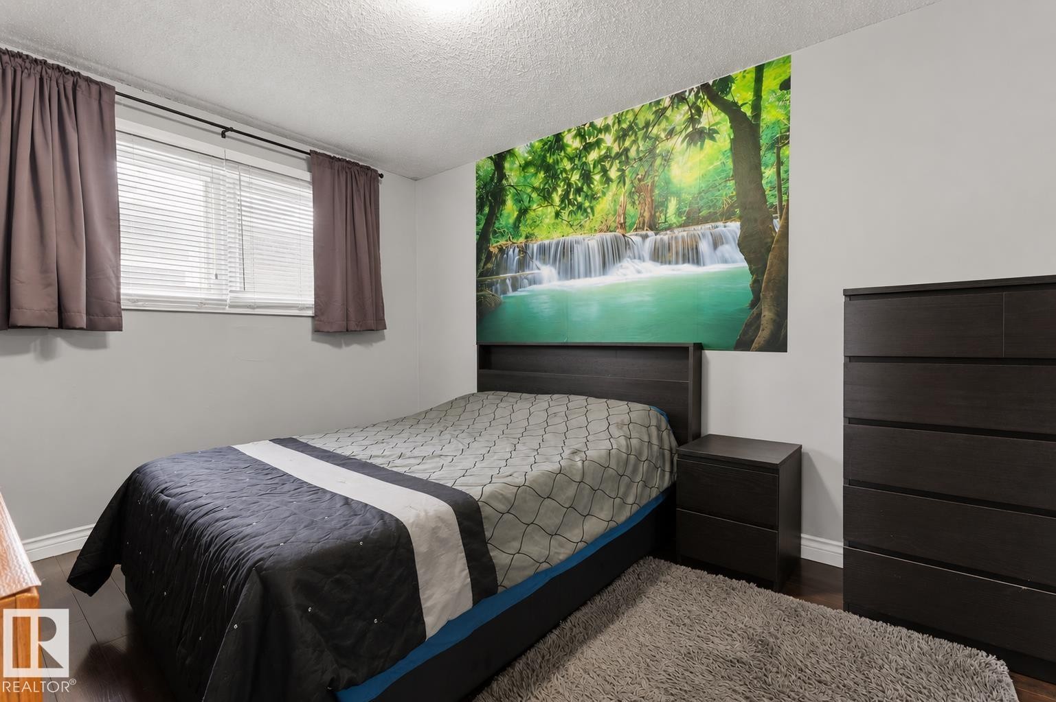 Bedroom featuring dark wood-finish flooring, a double window with blinds, and a large wall mural - 11234 40 Avenue Nw, Edmonton, AB - Indoor Photo Showing Bedroom