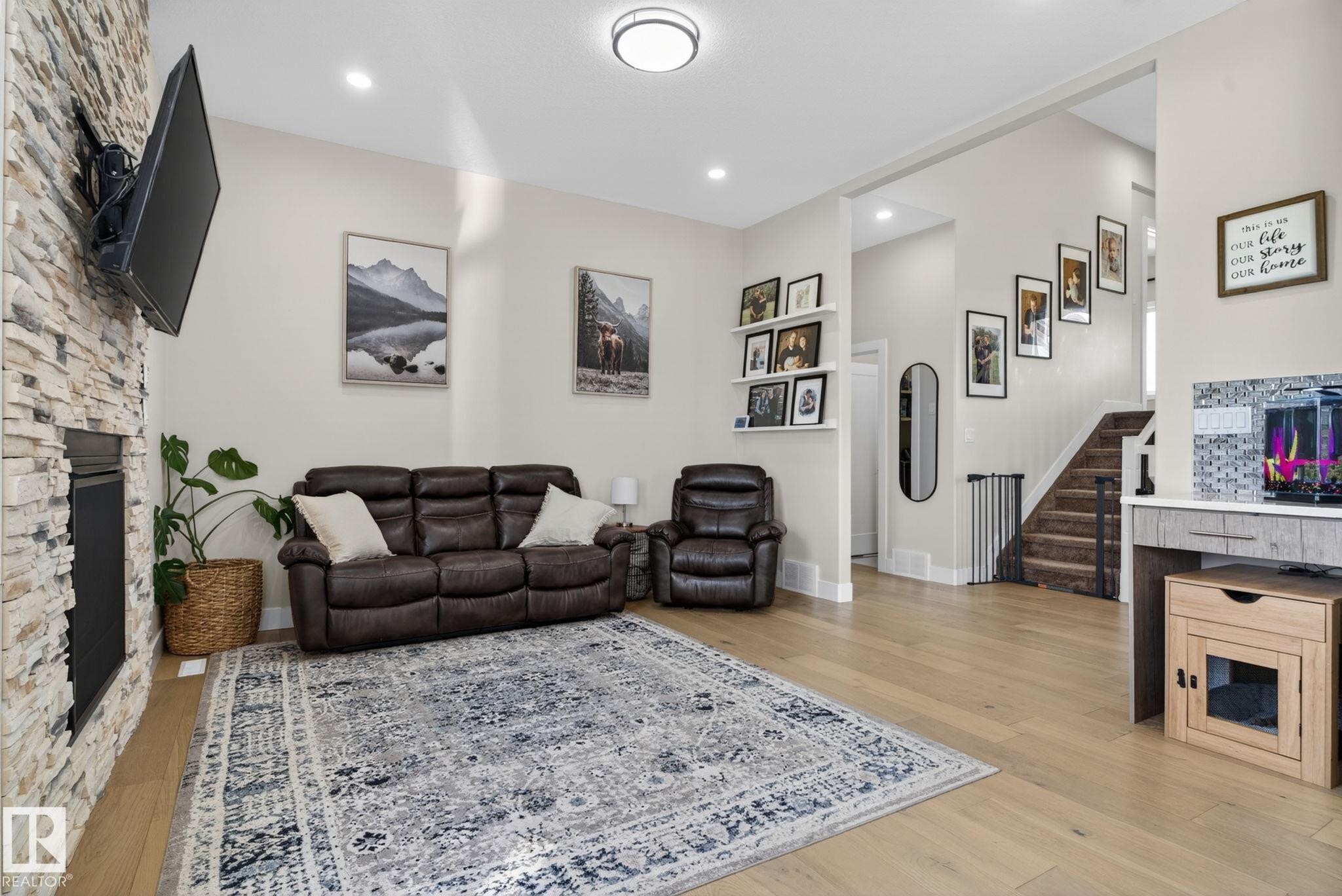 Spacious living area featuring light wood-finish flooring and recessed lighting - 4204 55Av, Lamont, AB
