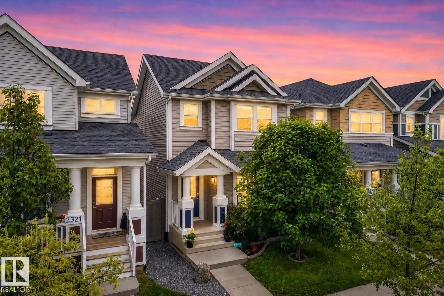 Multilevel townhome with a covered front porch featuring white pillars - 2325 69A Street, Edmonton, AB
