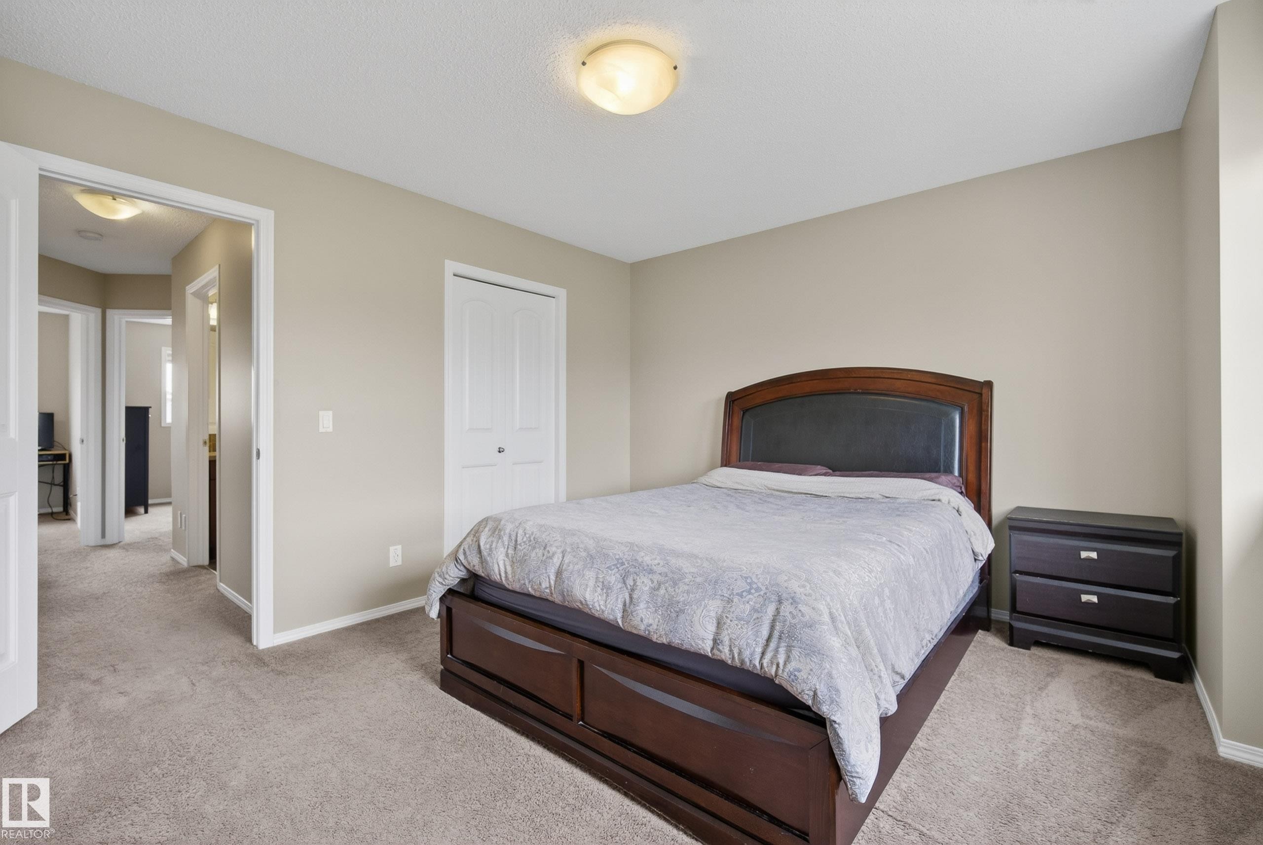 Neutral-toned walls and plush carpeting in this bedroom - 2325 69A Street, Edmonton, AB