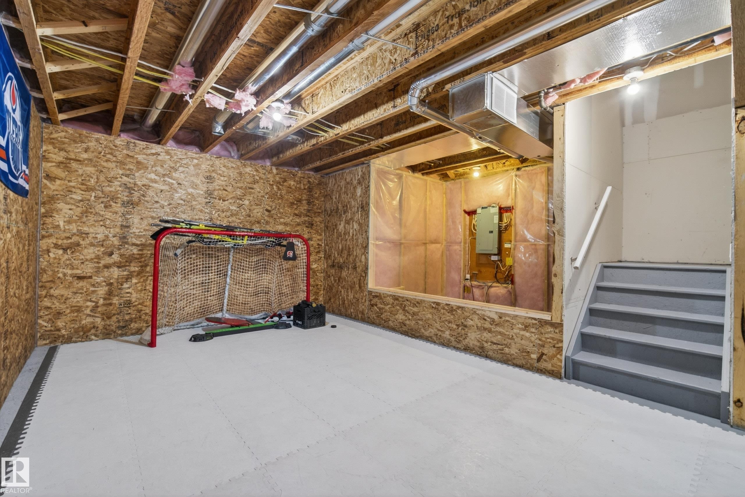 Unfinished lower level featuring exposed wood joists and oriented strand board walls - 2325 69A Street, Edmonton, AB