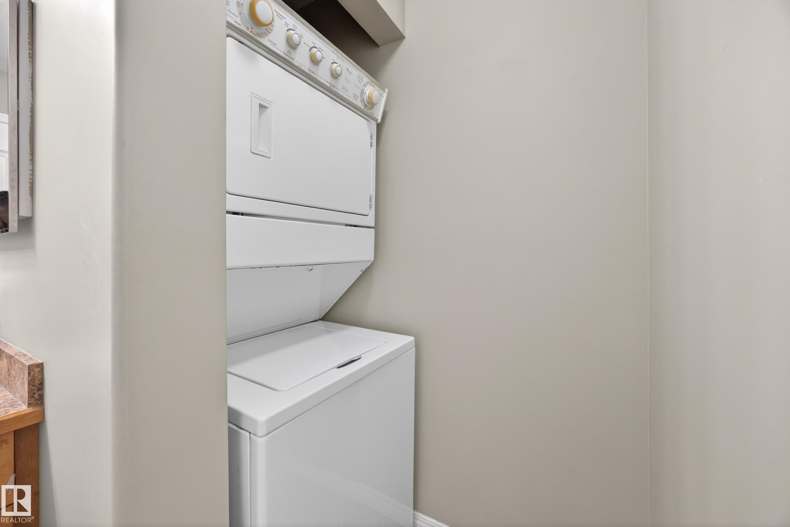Stacked washer and dryer unit within a dedicated alcove - 111 3425 19, Edmonton, AB