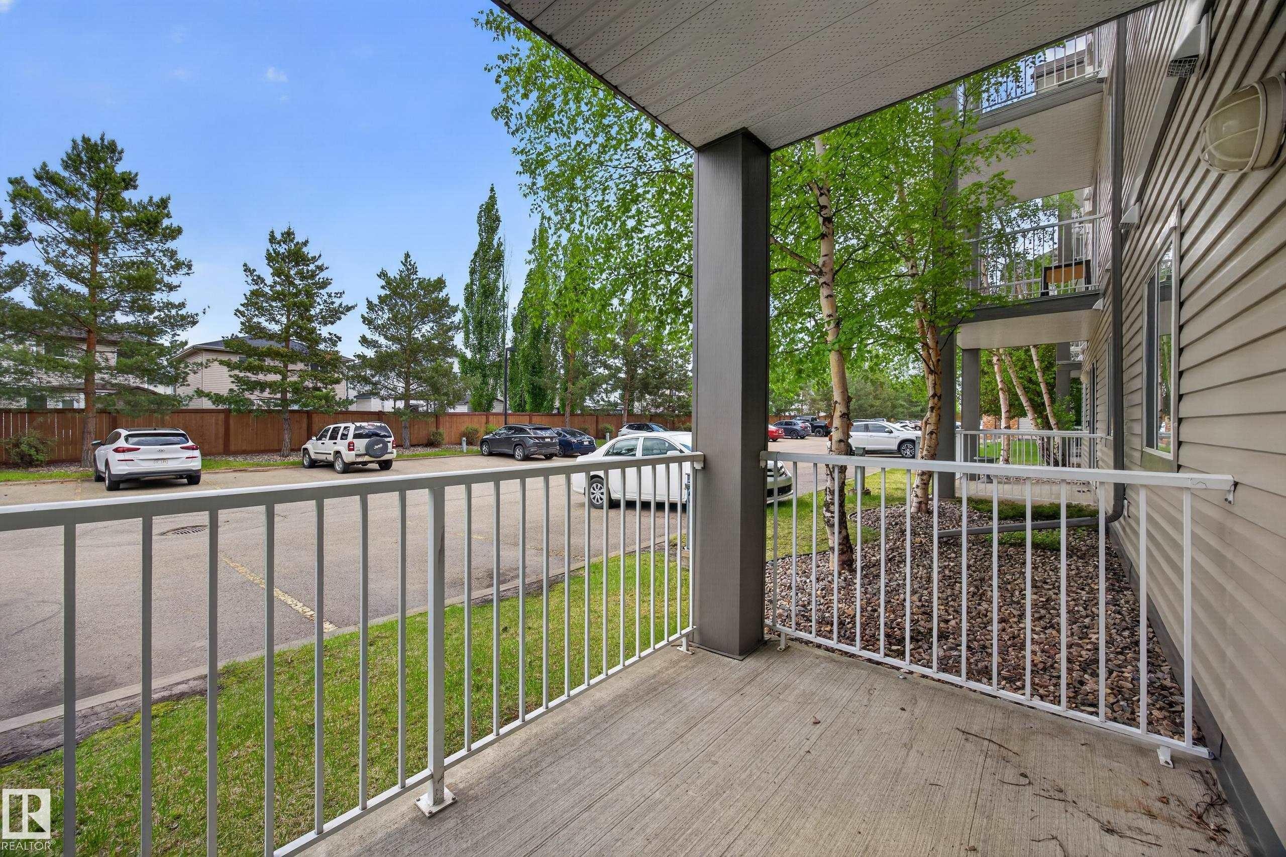 Private concrete patio with white metal railing - 111 3425 19, Edmonton, AB