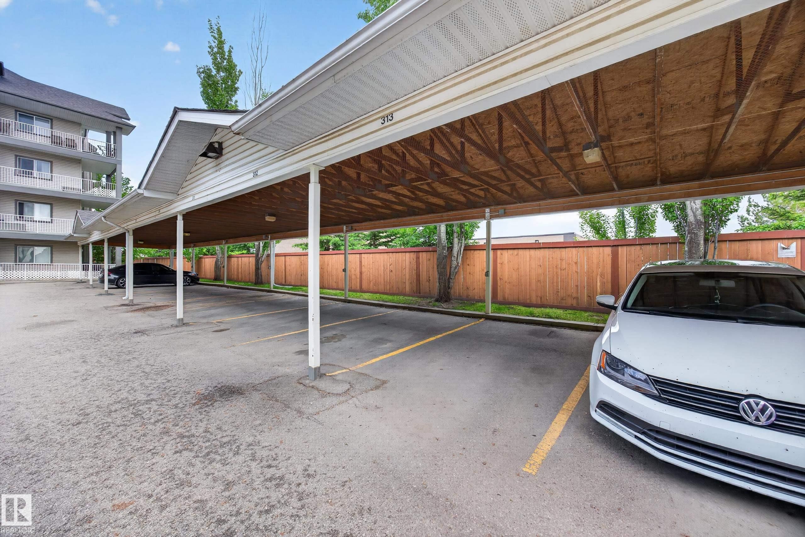 Covered parking structure with multiple spaces, featuring a light-colored soffit and a wood-finish ceiling - 111 3425 19, Edmonton, AB