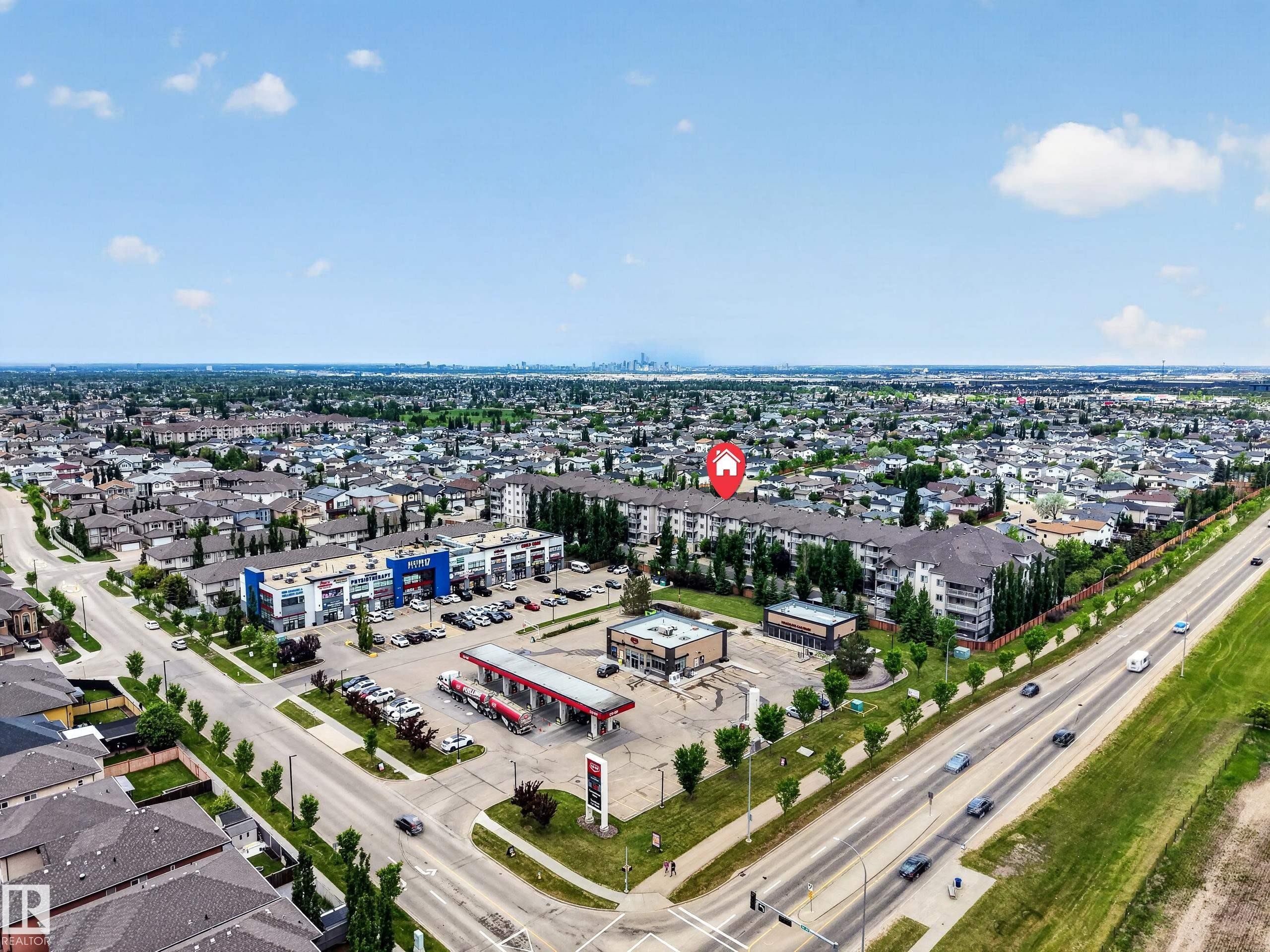 Residential buildings featuring dark shingle roofing and light-colored siding - 111 3425 19, Edmonton, AB