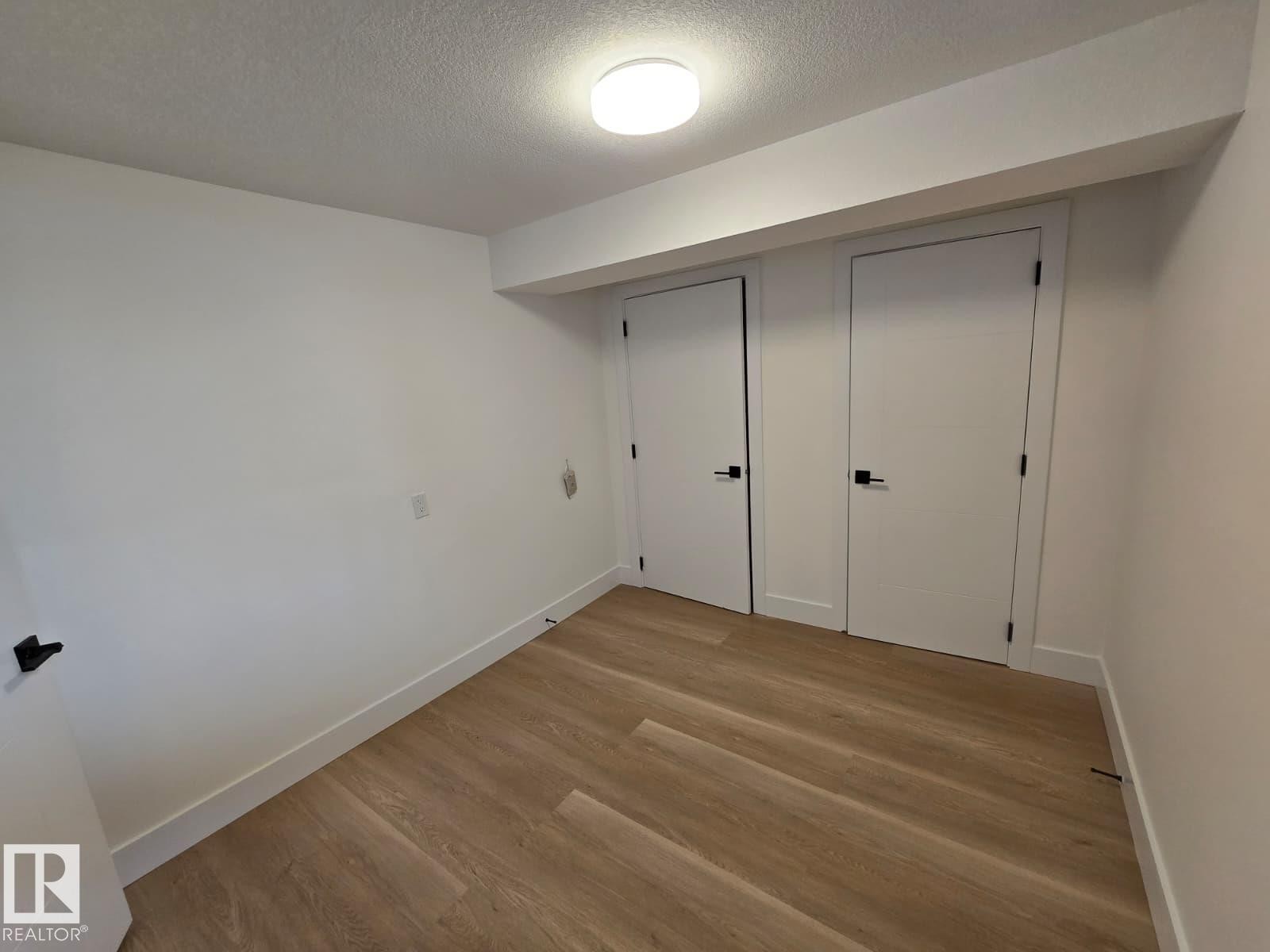 Room featuring light wood-finish flooring, white walls, and bright overhead lighting - 18526 86A Avenue, Edmonton, AB - Indoor Photo Showing Other Room