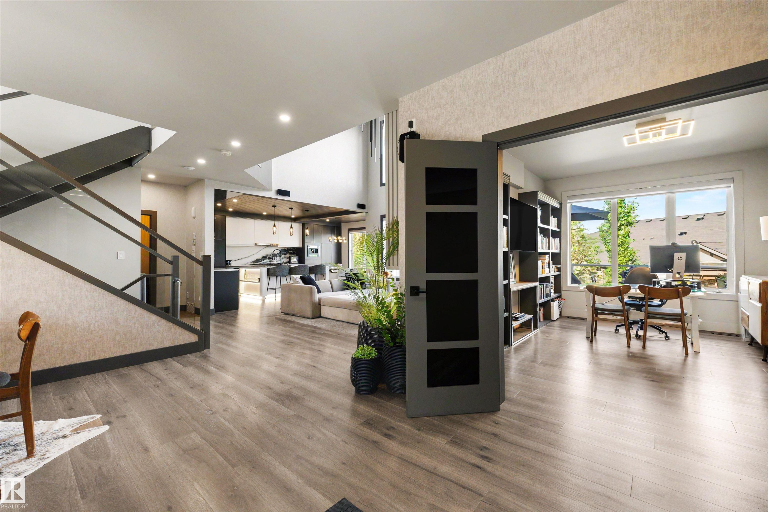 Open concept interior featuring wide plank wood-finish flooring throughout - 4376 Mcclung Crescent Nw, Edmonton, AB - Indoor