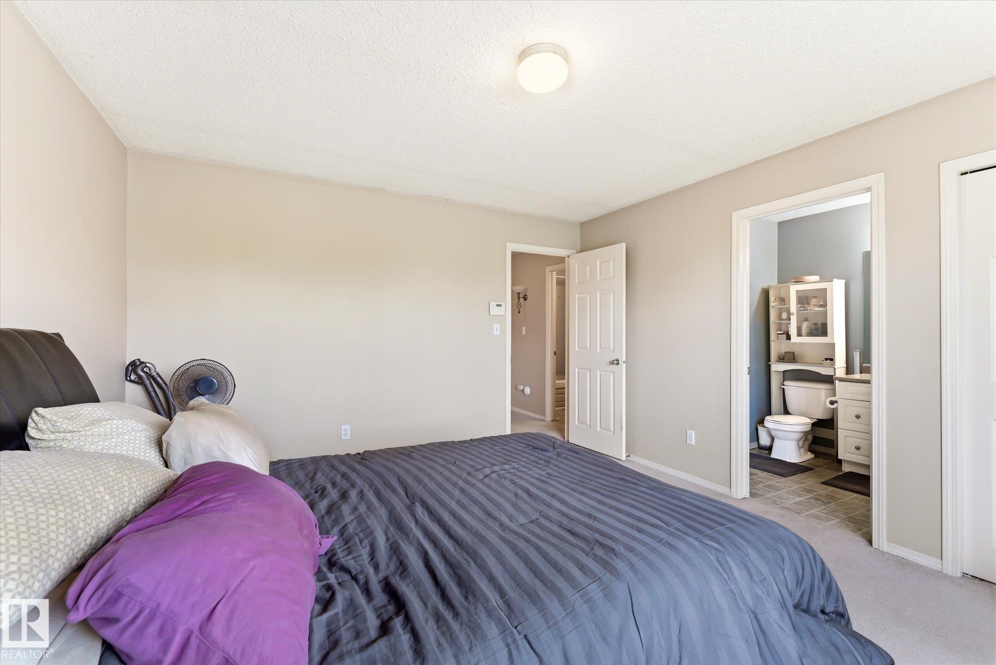 Neutral tone walls with an overhead flush mount light fixture - #37 4020 21 St Nw, Edmonton, AB - Indoor Photo Showing Bedroom