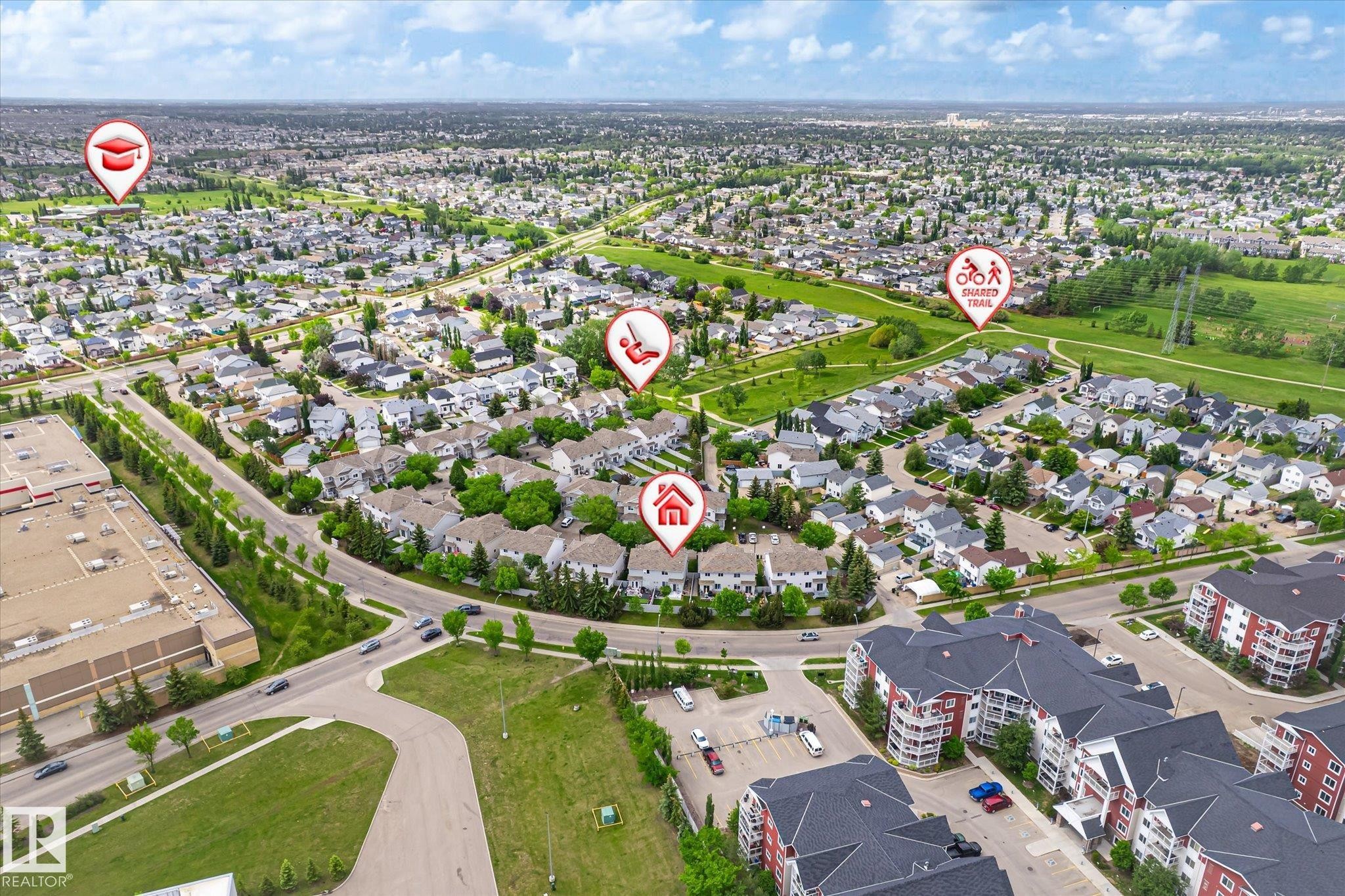 Expansive aerial perspective showcasing a residential neighborhood with diverse housing styles, including multi-story apartment buildings and single-family homes - #37 4020 21 St Nw, Edmonton, AB - Outdoor With View