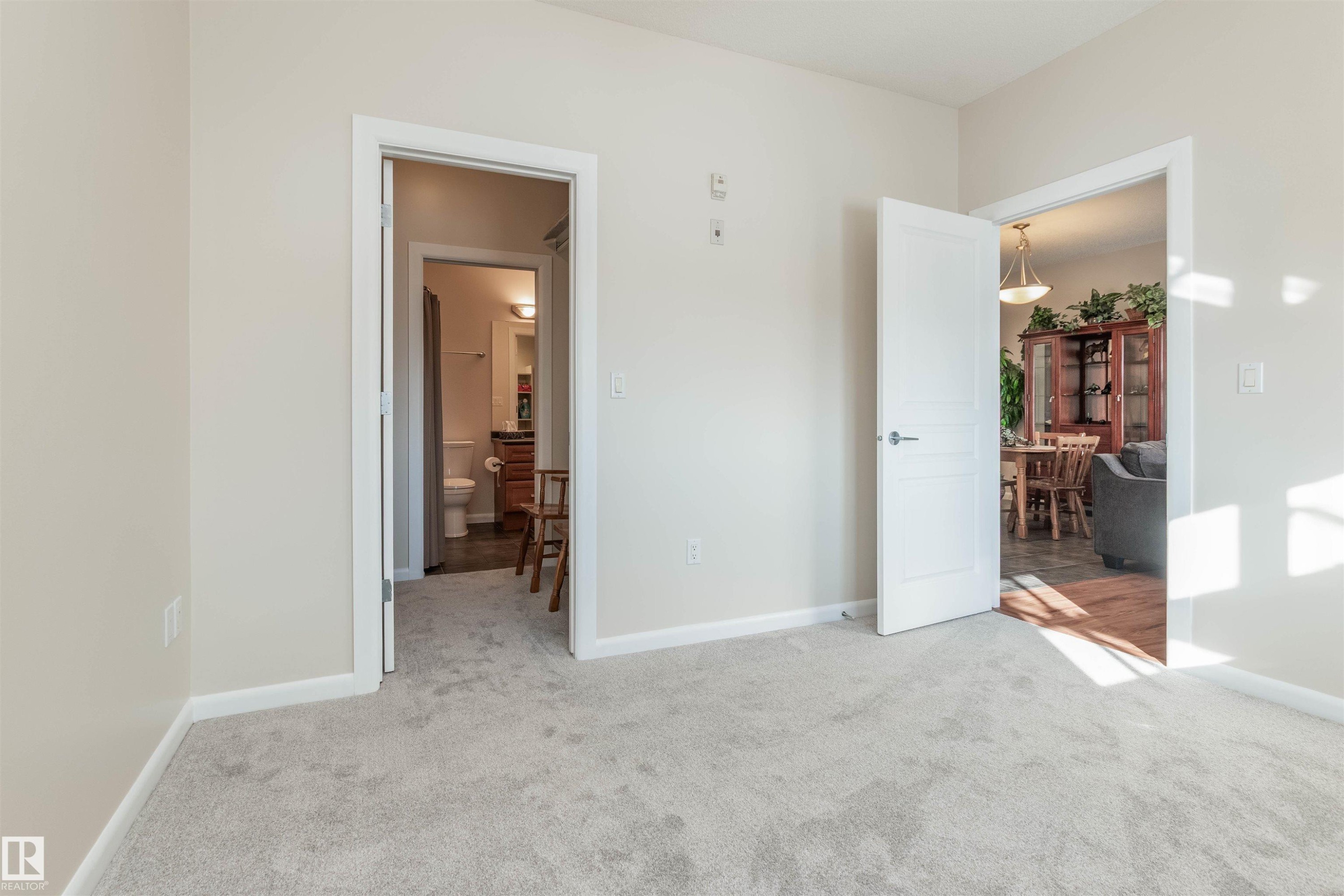 Light-colored carpeting with painted walls and white trim - 439 300 Palisades Way, Sherwood Park, AB - Indoor Photo Showing Other Room
