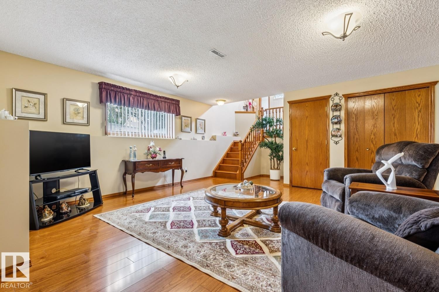 Living room features a double sided gas fireplace - 5131 152A Avenue, Edmonton, AB