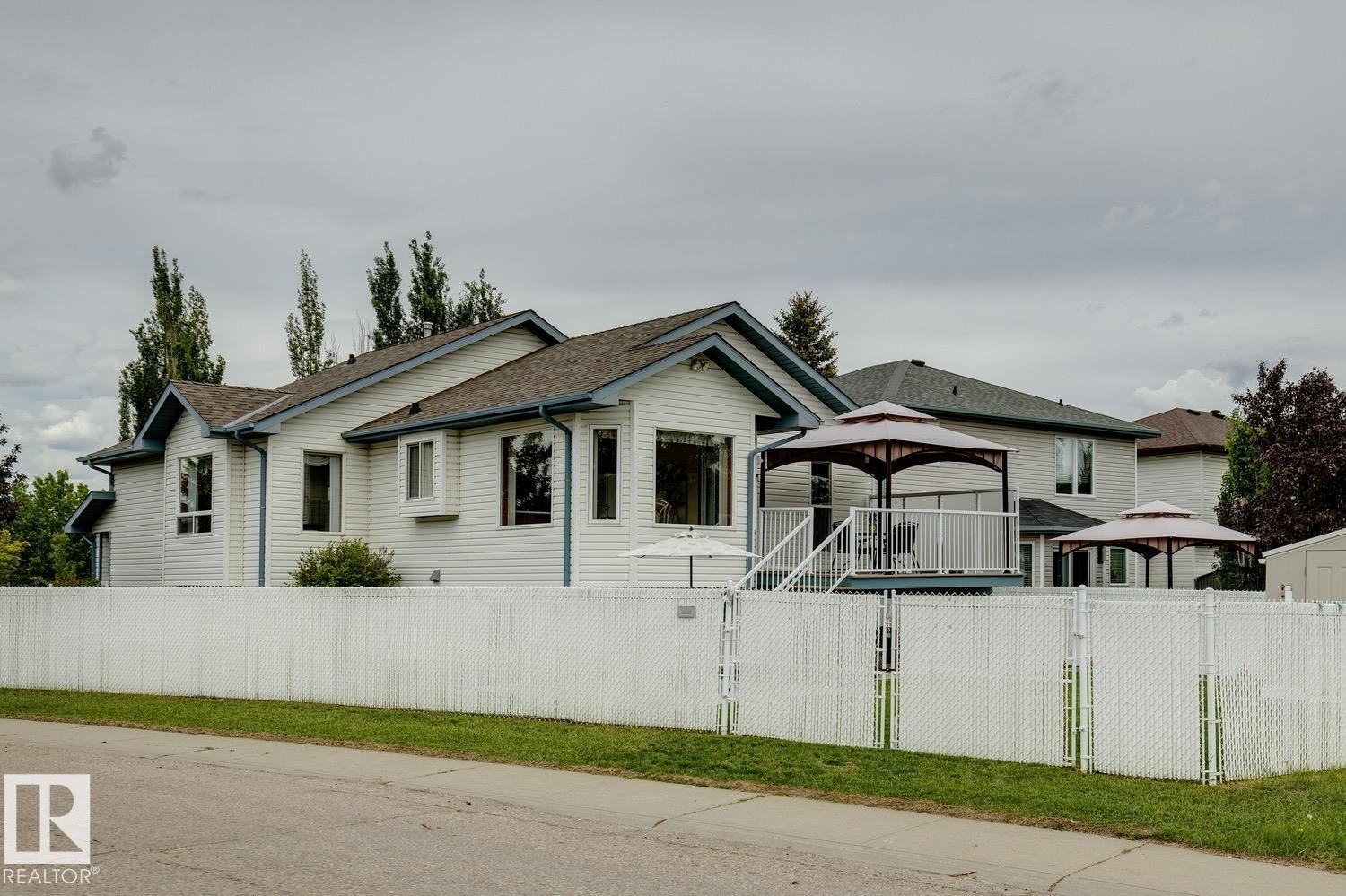 White vinyl siding exterior with dark trim accents and a brown shingle roof - 5131 152A Avenue, Edmonton, AB