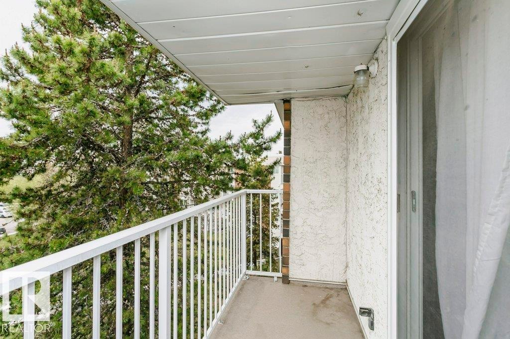 Private balcony featuring a concrete floor, white metal railing, and textured exterior wall - 71 11255 31 Avenue, Edmonton, AB - Outdoor With Exterior
