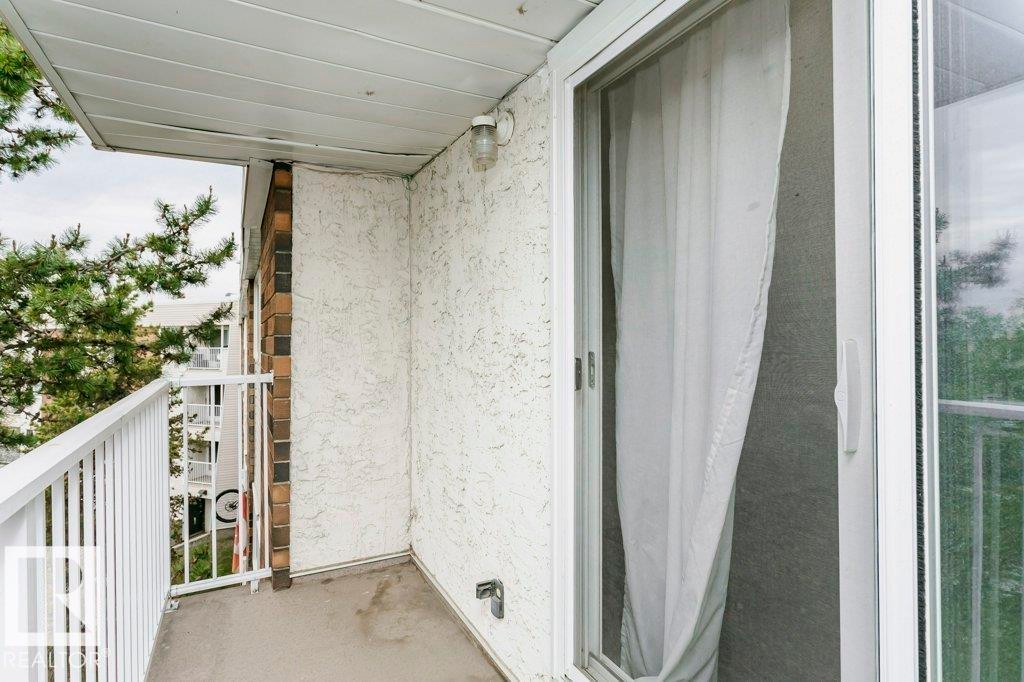 Private balcony featuring a concrete floor, white metal railing, and textured stucco exterior - 71 11255 31 Avenue, Edmonton, AB - Outdoor With Exterior