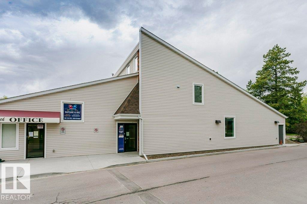 Commercial building exterior featuring light-colored siding and an asymmetrical roofline - 71 11255 31 Avenue, Edmonton, AB - Outdoor With Exterior
