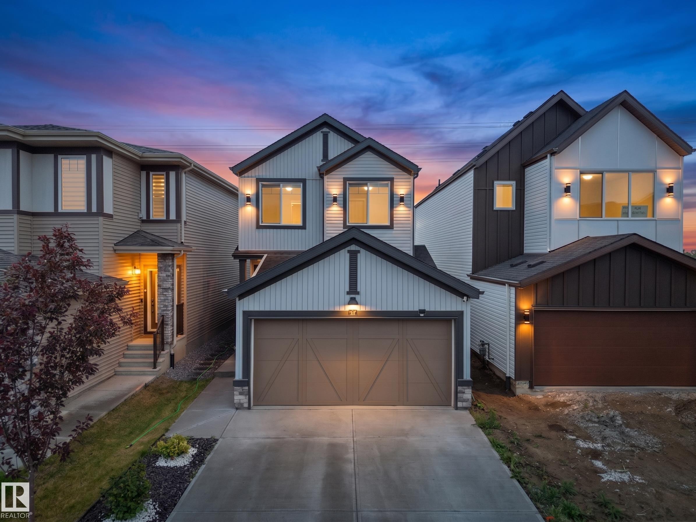 Modern architectural style featuring light-colored horizontal siding, vertical dark siding, and dark trim - 19316 29 Avenue, Edmonton, AB