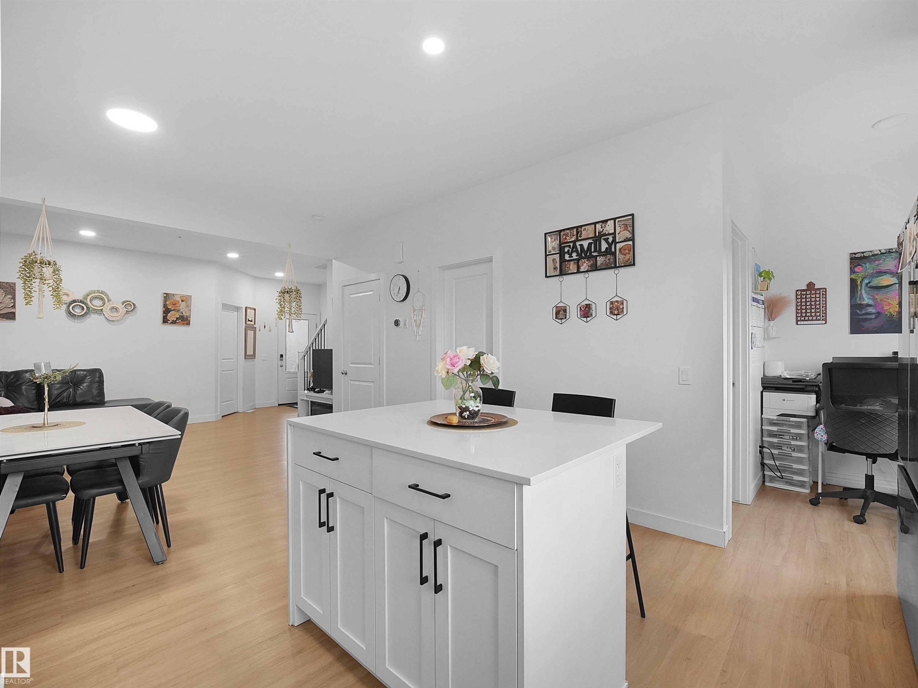 White kitchen island with a light-colored countertop and dark hardware - 19316 29 Avenue, Edmonton, AB