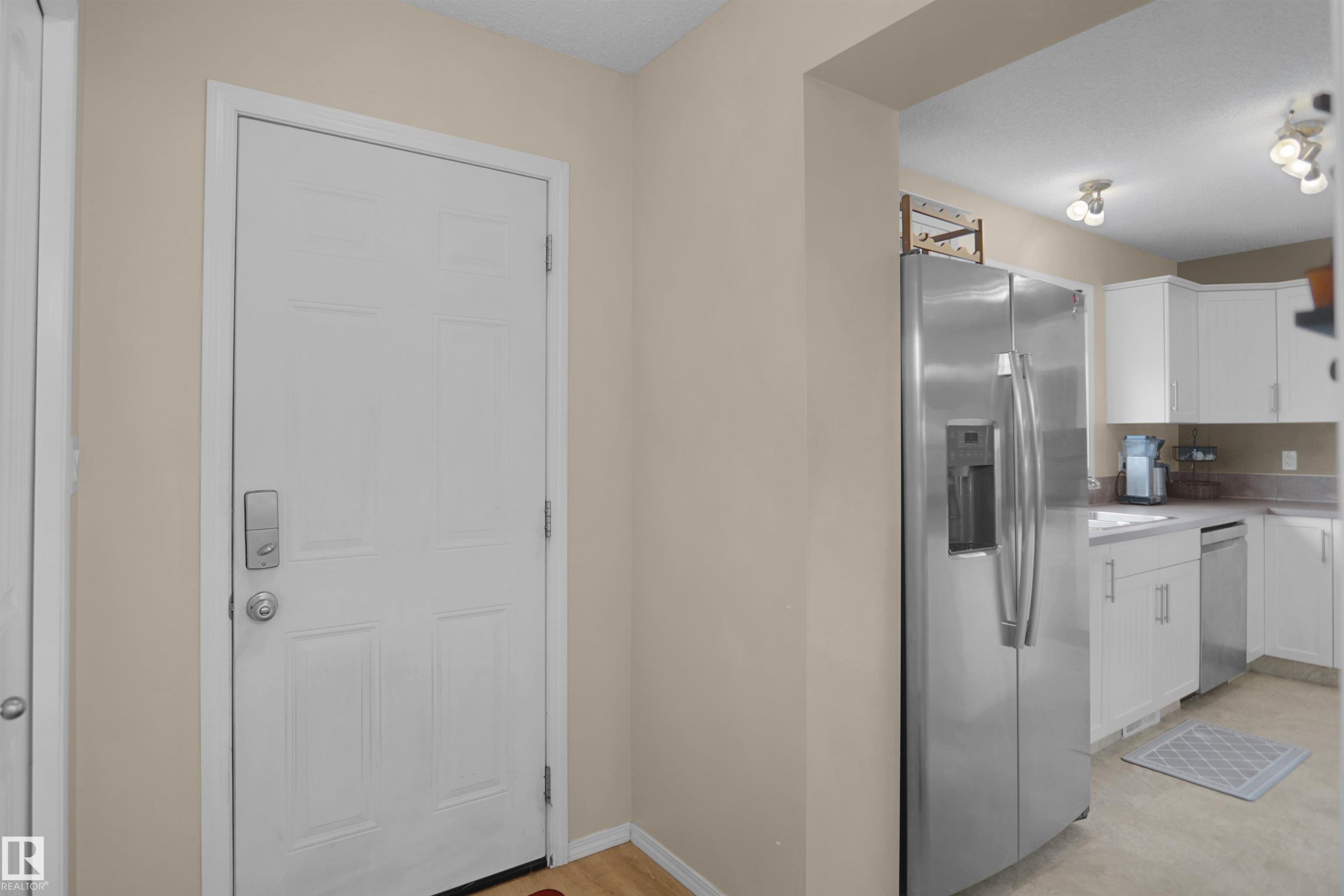 Entryway featuring a paneled door with smart lock hardware - 292 Simmonds Way, Leduc, AB