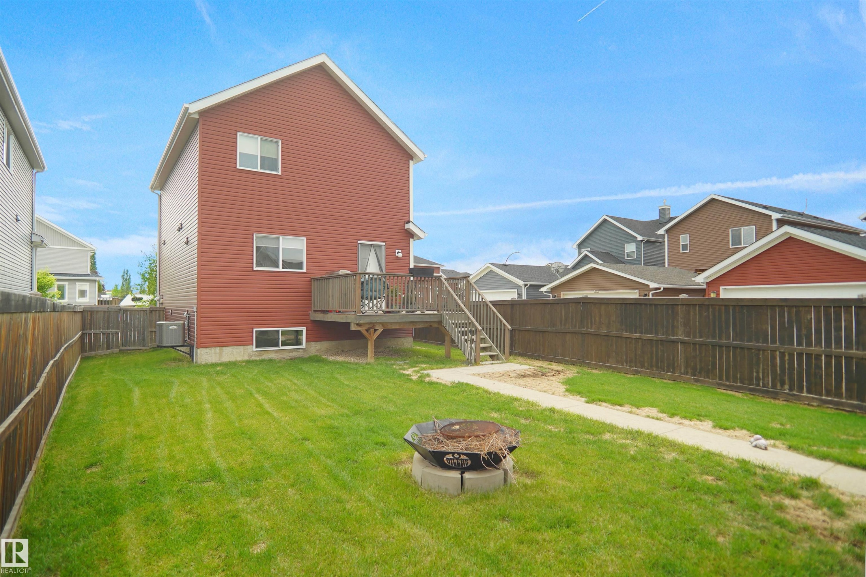 Two-story residence with red siding and white trim - 292 Simmonds Way, Leduc, AB