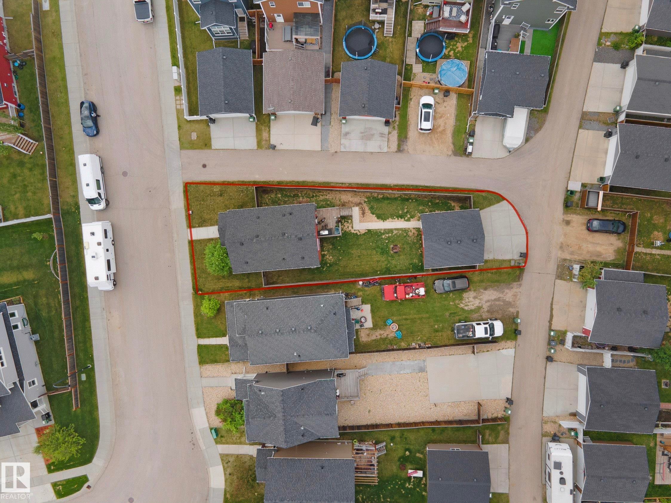 Residential property featuring two single-story structures with dark shingled roofs - 292 Simmonds Way, Leduc, AB