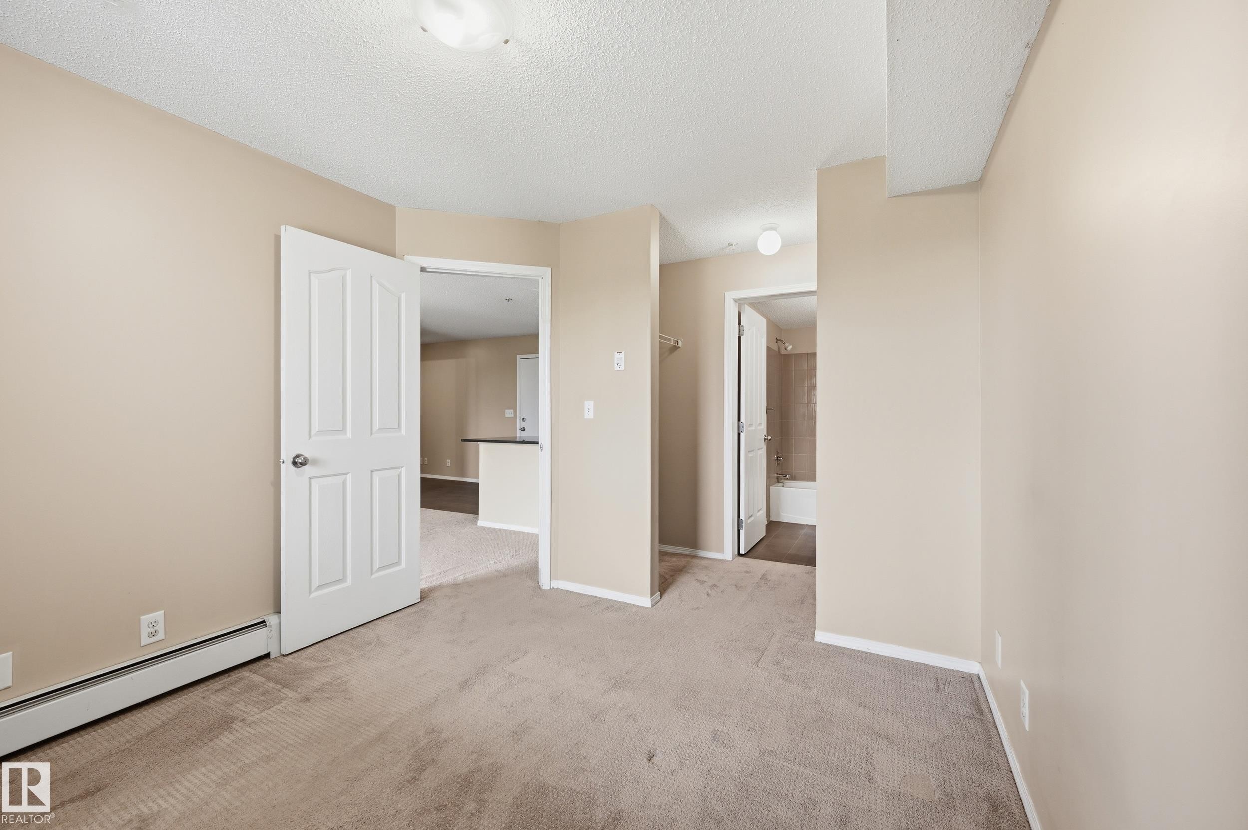 Neutral-toned carpeting throughout - 304 11804 22 Avenue, Edmonton, AB