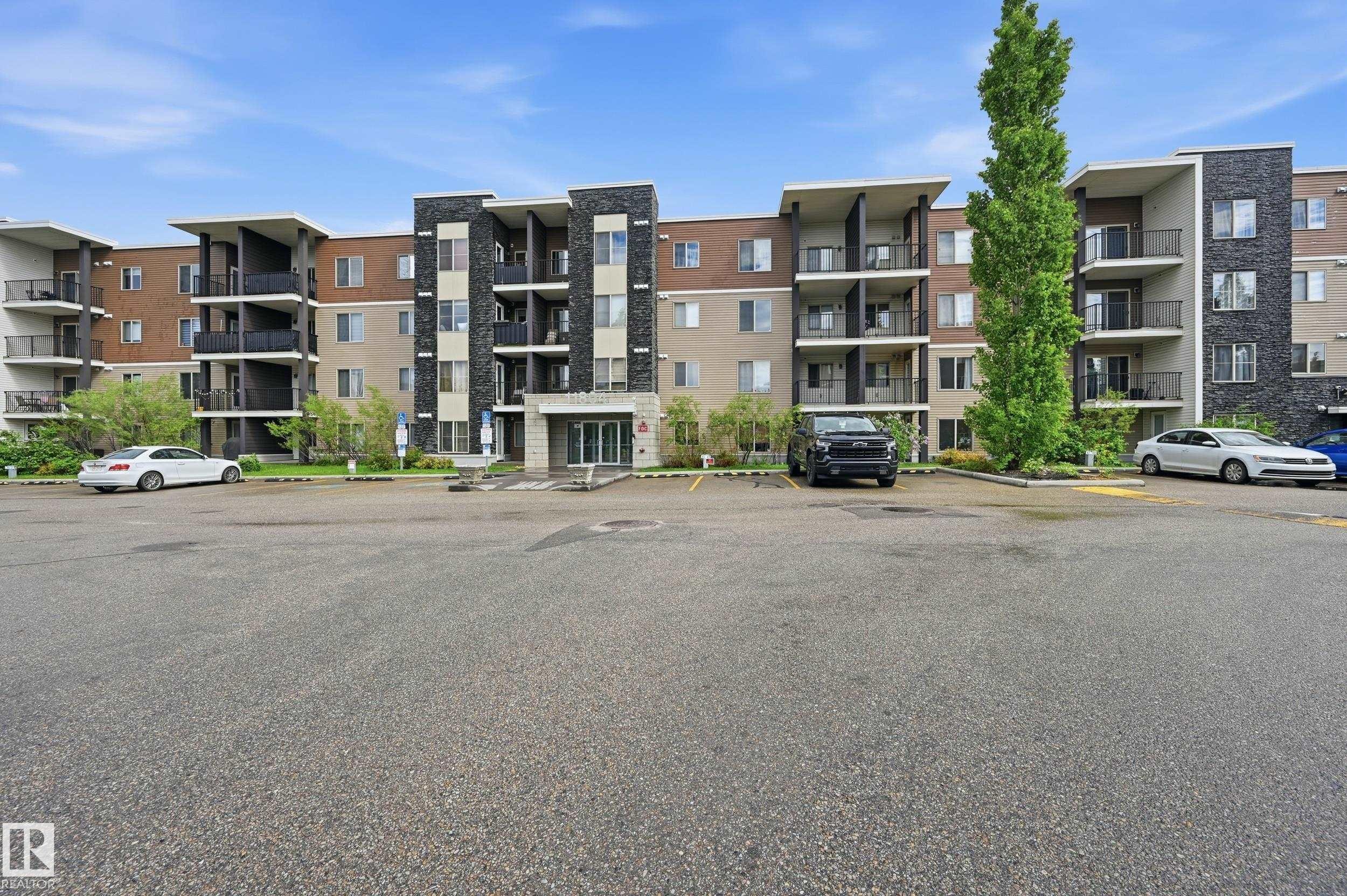 Multi-story building featuring a brick and stone facade with multiple balconies - 304 11804 22 Avenue, Edmonton, AB