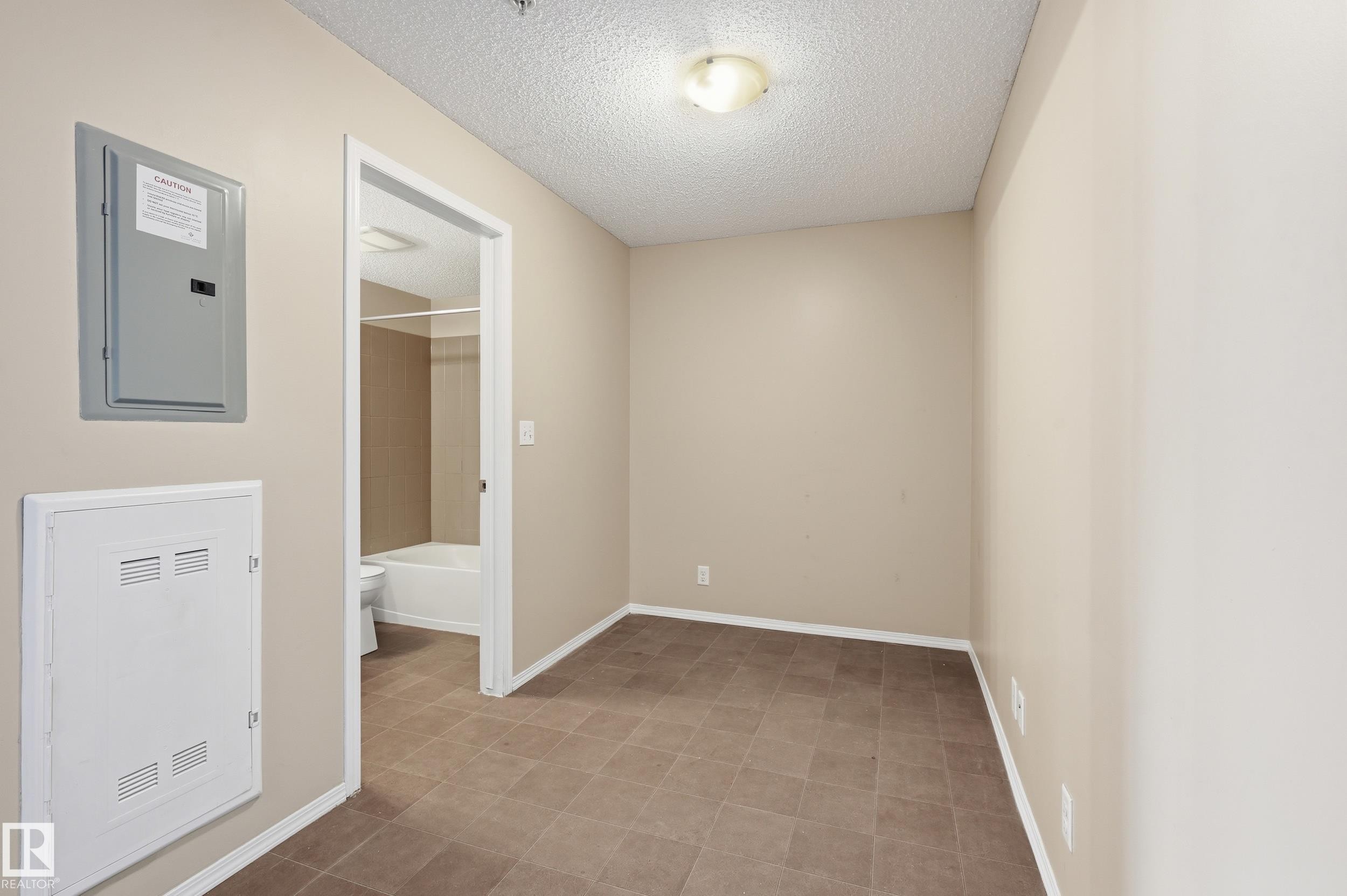 Room featuring neutral wall tones and tile flooring - 304 11804 22 Avenue, Edmonton, AB