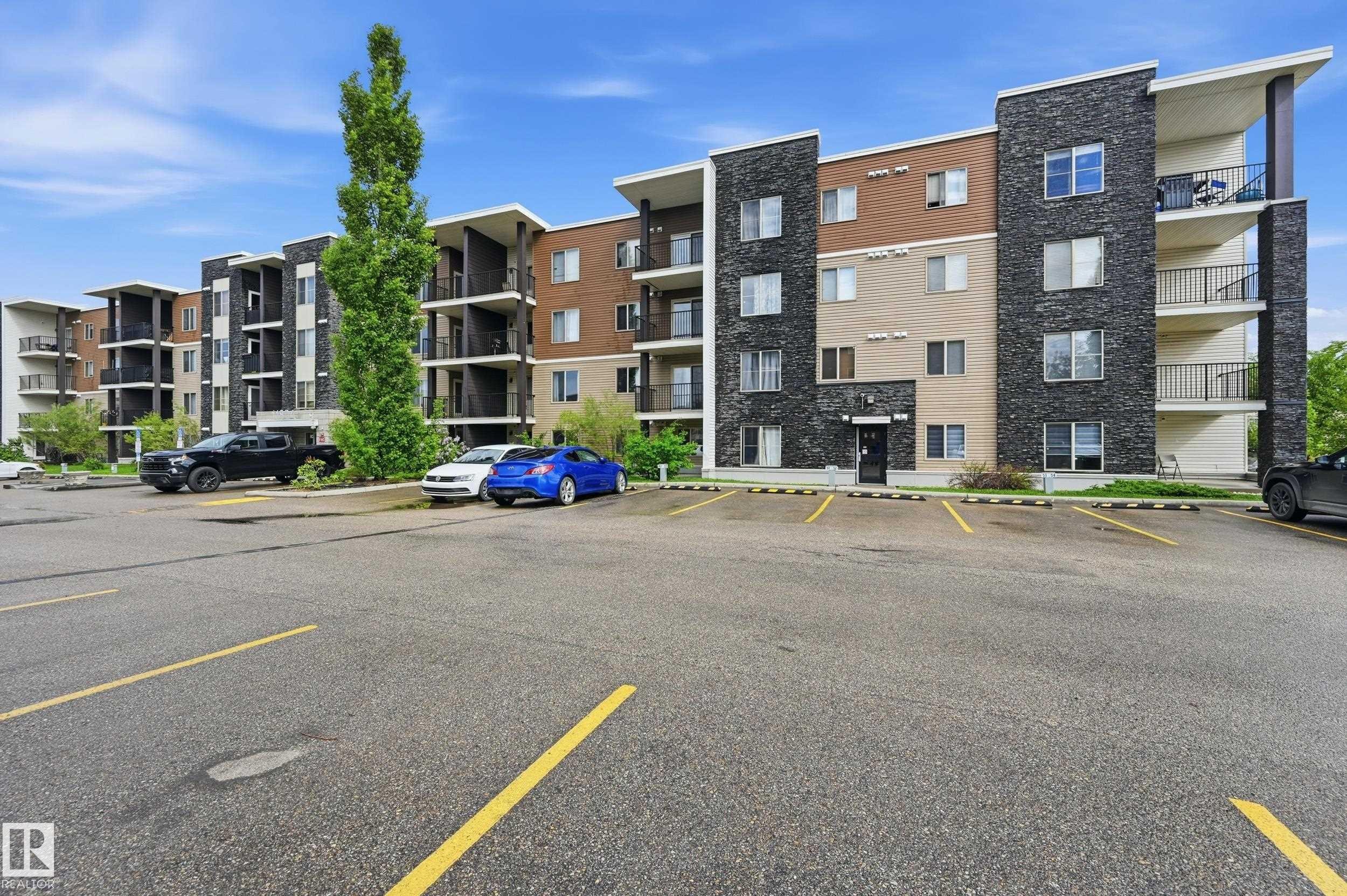 Multi-story residential building featuring a stone and siding exterior - 304 11804 22 Avenue, Edmonton, AB