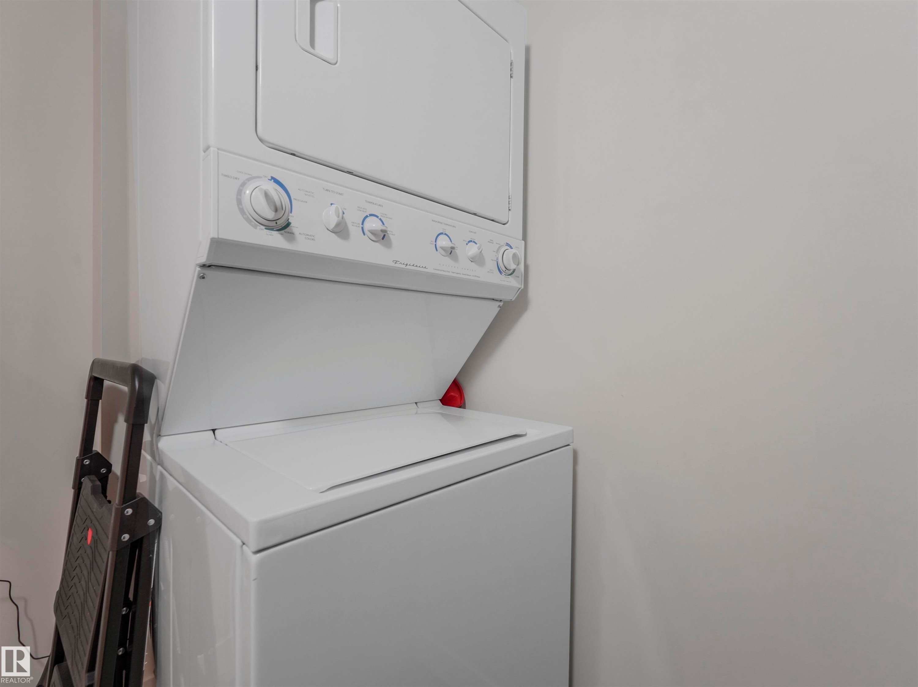 Stackable washer and dryer unit - #409 10333 112 St Nw, Edmonton, AB - Indoor Photo Showing Laundry Room