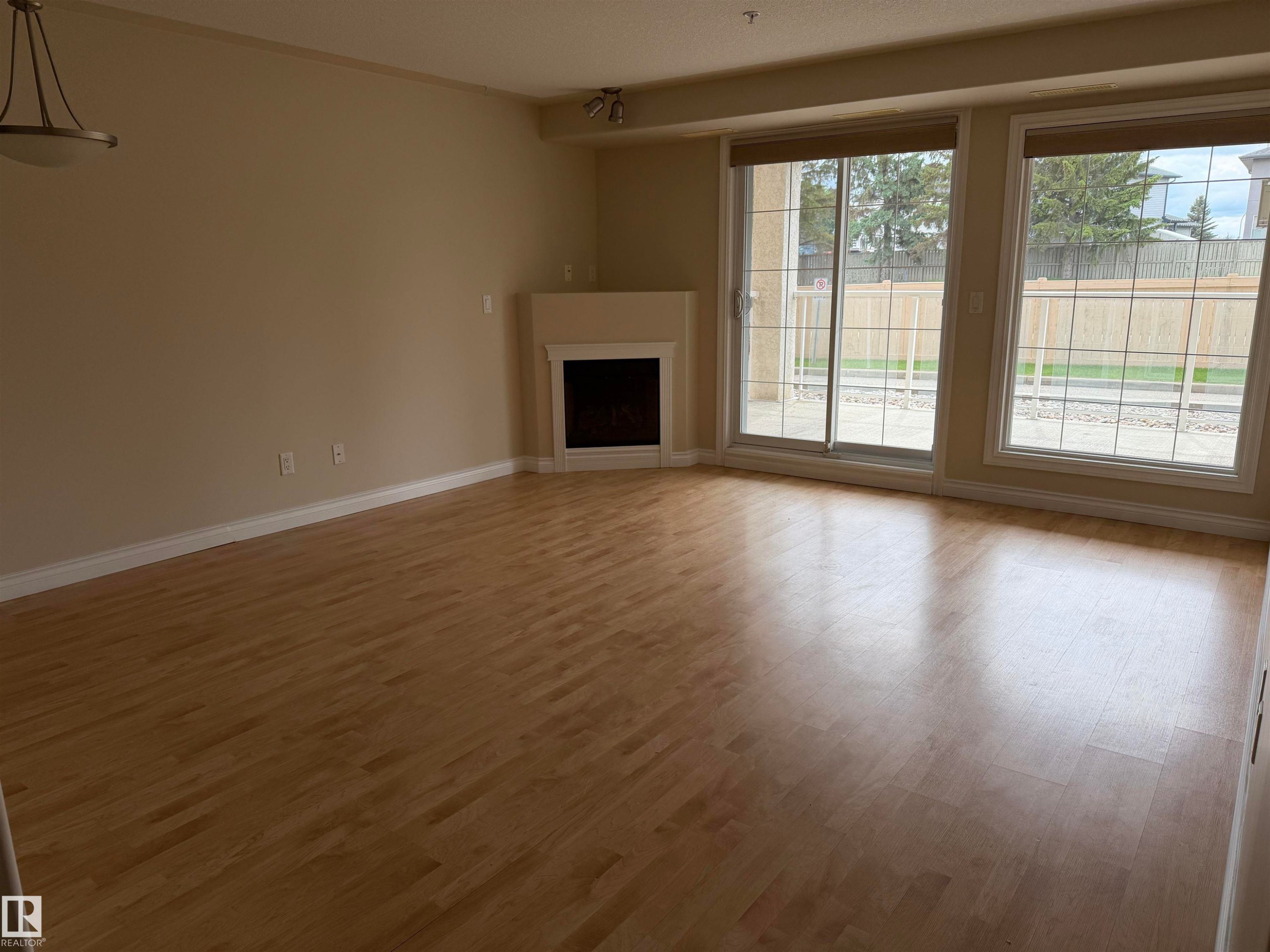 Open living area with light wood-finish flooring - 118 7801 Golf Course Road, Stony Plain, AB