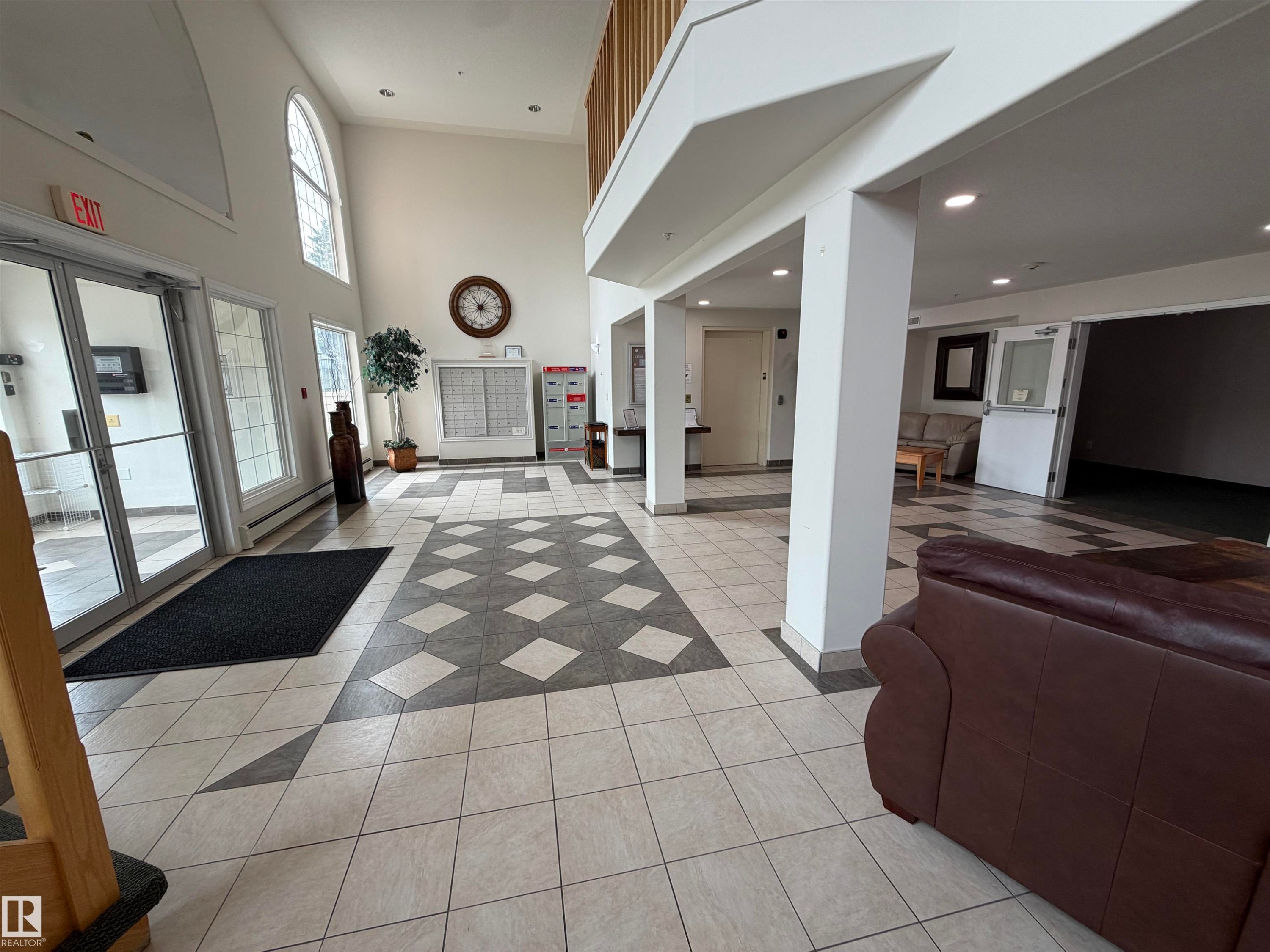 Spacious entryway featuring a decorative tile floor pattern - 118 7801 Golf Course Road, Stony Plain, AB