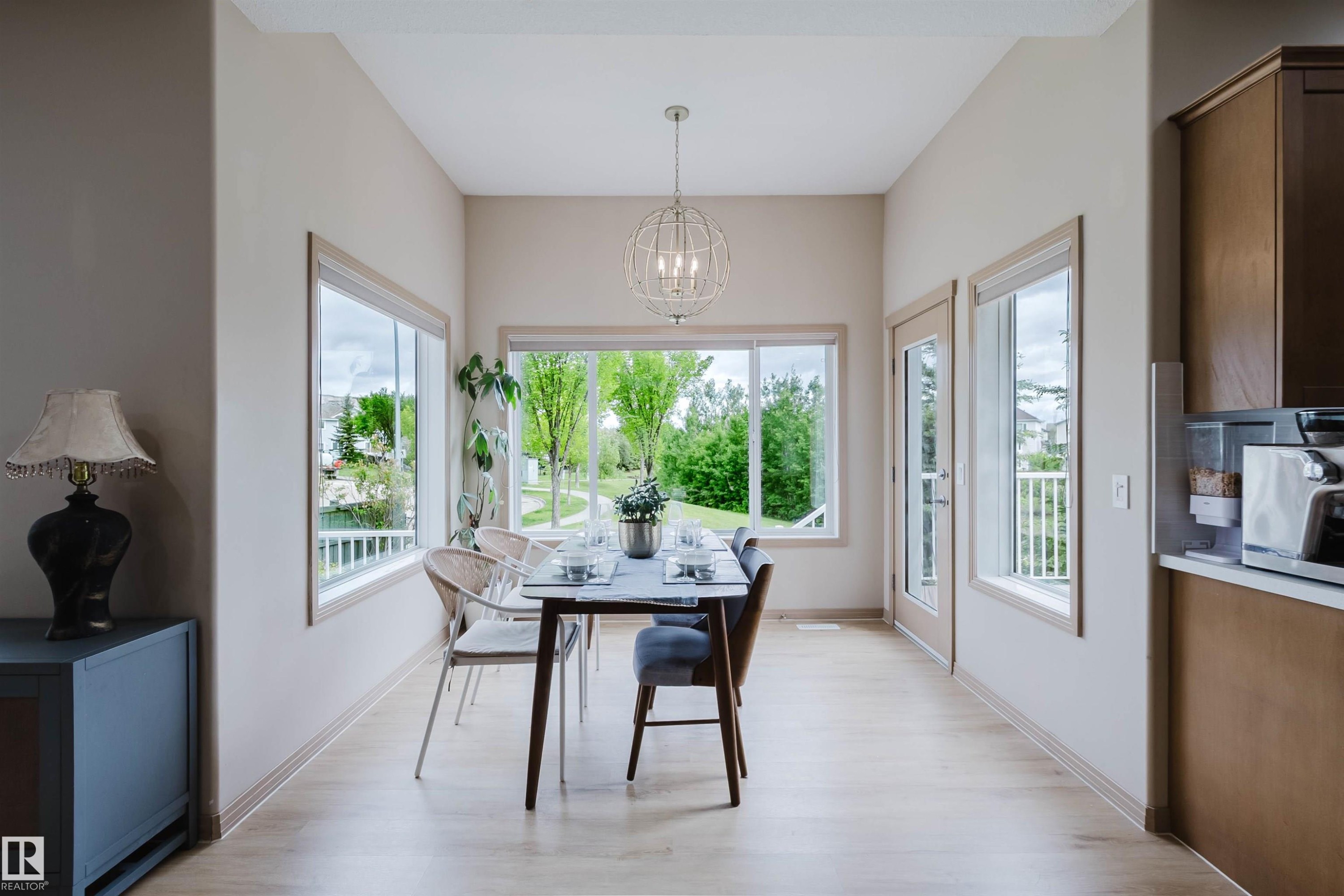 Dining area with wood-finish flooring and neutral wall tones - 2236 Garnett Crest, Edmonton, AB