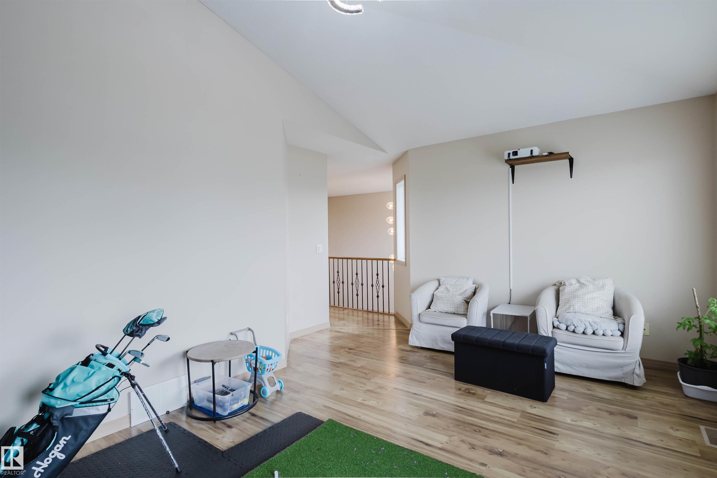 Open common area featuring wood-finish flooring, light-toned walls, and a recessed ceiling light - 2236 Garnett Crest, Edmonton, AB