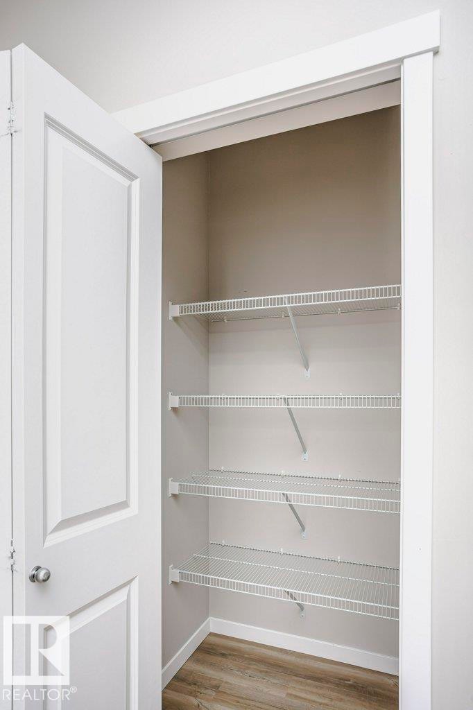 This property offers practical storage solutions, featuring an interior closet with wire shelving and durable flooring - 320 Secord Boulevard, Edmonton, AB - Indoor With Storage