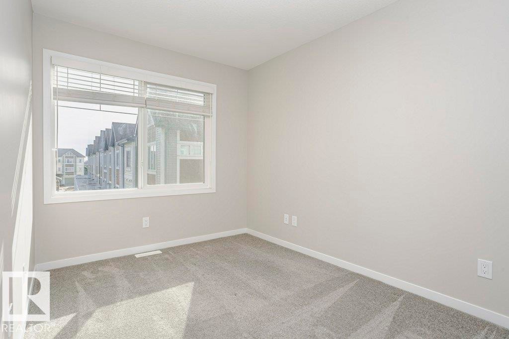 Bright room featuring a window with blinds, light-colored walls, and carpeting - 320 Secord Boulevard, Edmonton, AB - Indoor Photo Showing Other Room