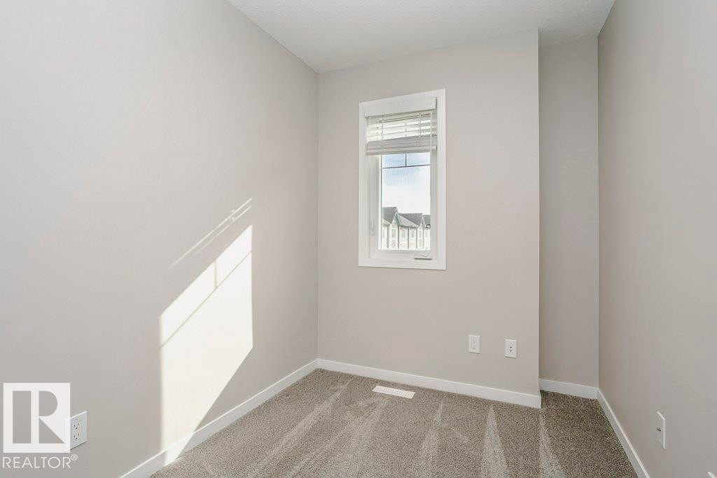 Room with light grey walls, white trim, and grey carpet - 320 Secord Boulevard, Edmonton, AB - Indoor Photo Showing Other Room