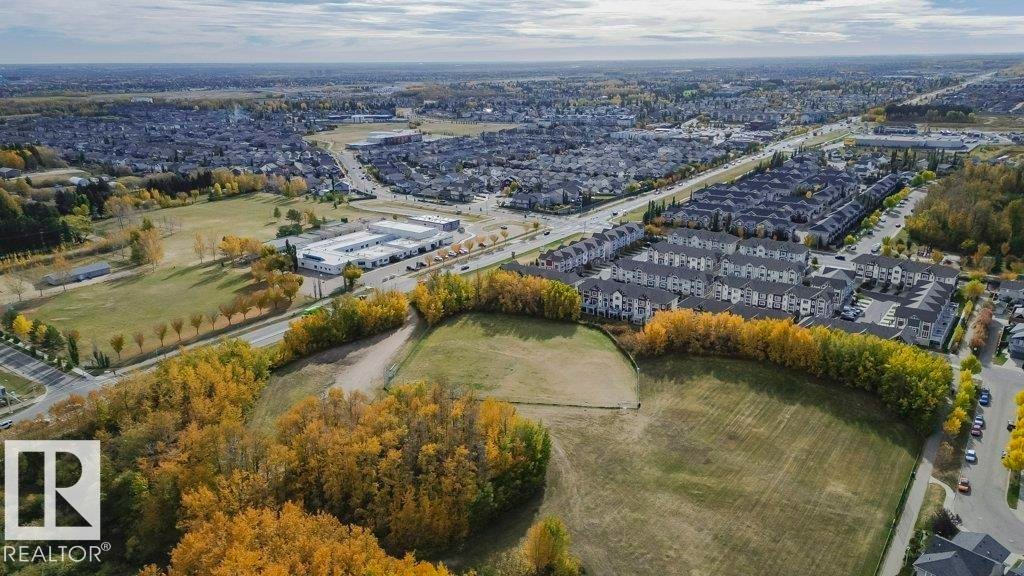 Expansive aerial view showcasing the surrounding residential area and abundant green spaces - 320 Secord Boulevard, Edmonton, AB - Outdoor With View