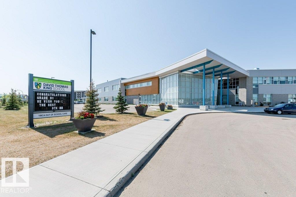 The property is in a modern architectural style with prominent large glass windows and an inviting entrance - 320 Secord Boulevard, Edmonton, AB - Outdoor